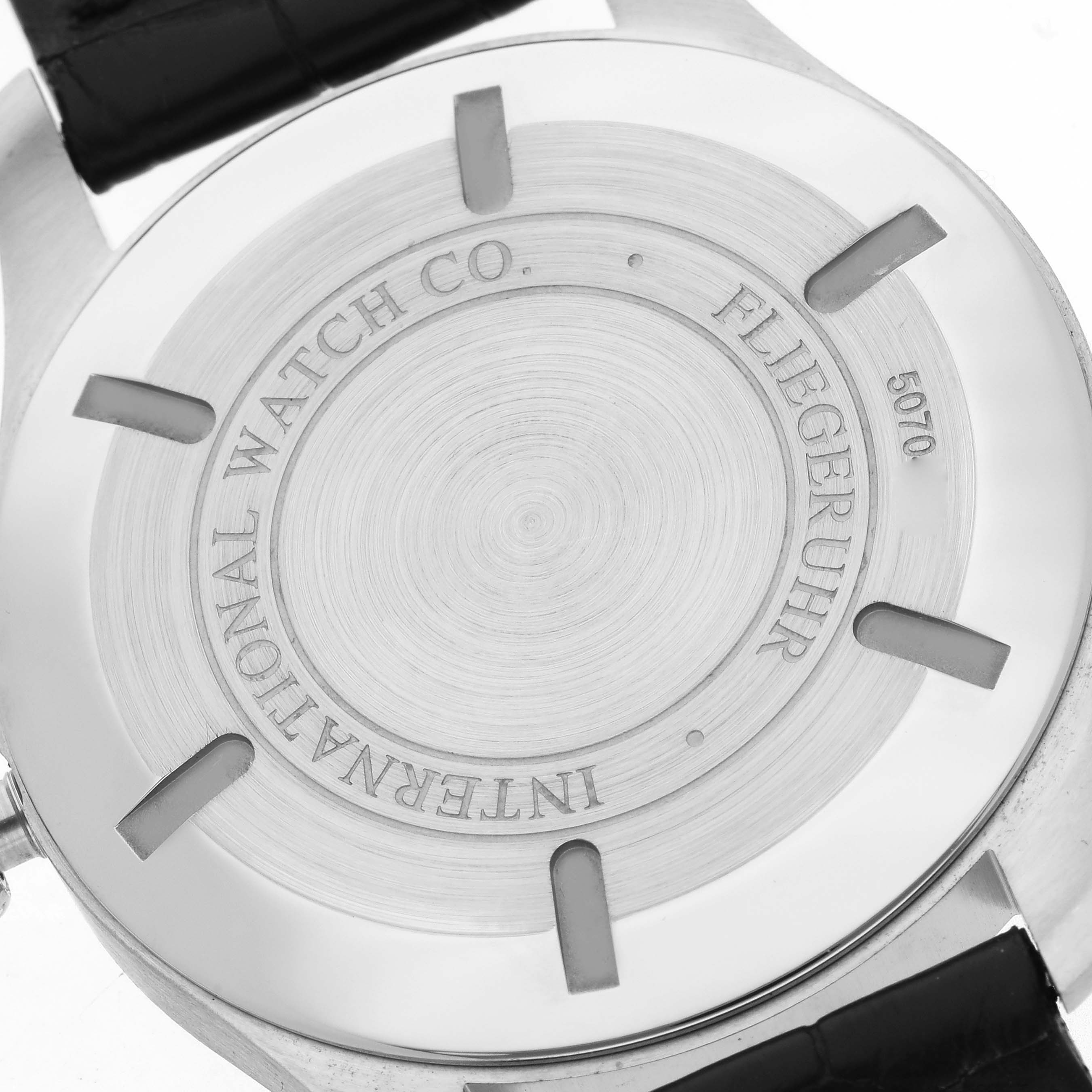 The image shows the back case of an IWC Pilot IW326501 Men's Stainless Steel Black Dial IW326501 Men's Stainless Steel Black Dial model watch, featuring engraved details.