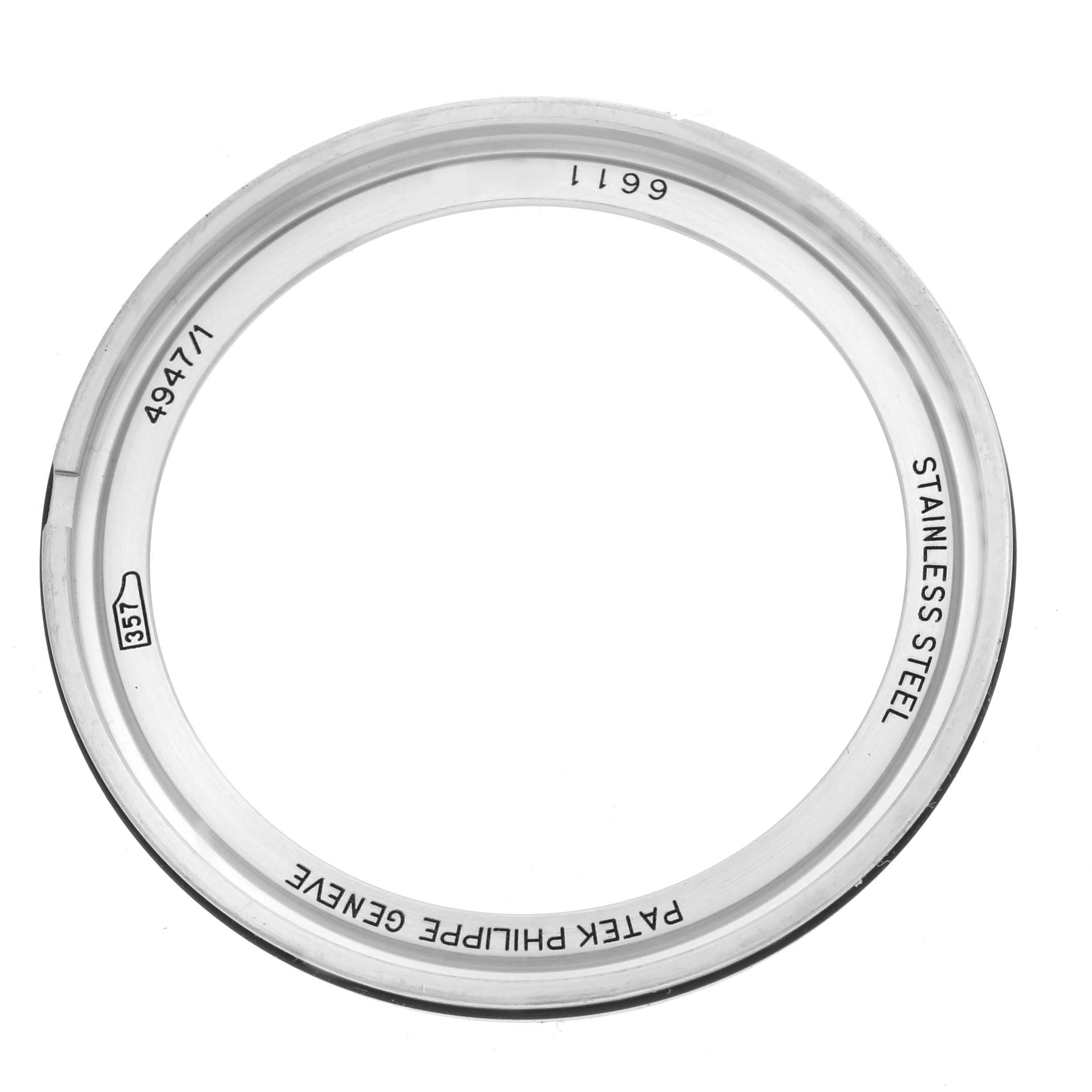 The image shows a bezel from a Patek Philippe Complications 4947/1A-001 Men's Stainless Steel Blue Dial 4947/1A-001 Men's Stainless Steel Blue Dial model, viewed from above with engraved details visible.