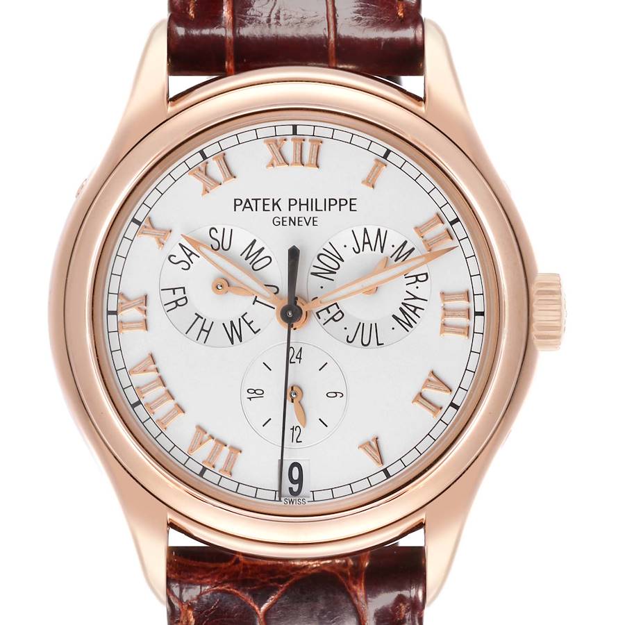 The Patek Philippe Complications watch is shown from the front, displaying the dial, hands, and calendar subdials.