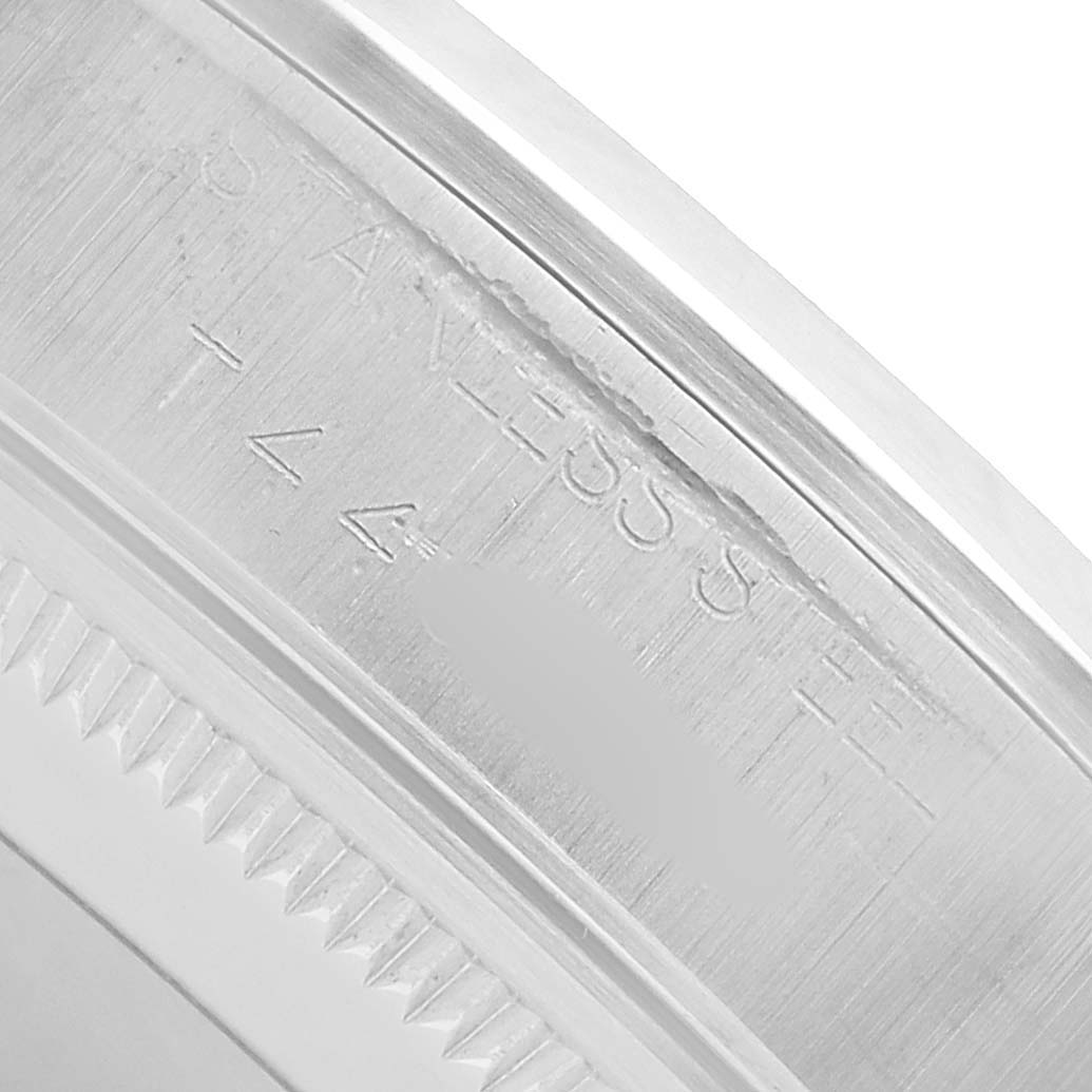 The image shows the inner bezel and part of the case side of a Rolex Oyster Perpetual 14000 Men's Stainless Steel Black Dial watch, focusing on the engraved markings.