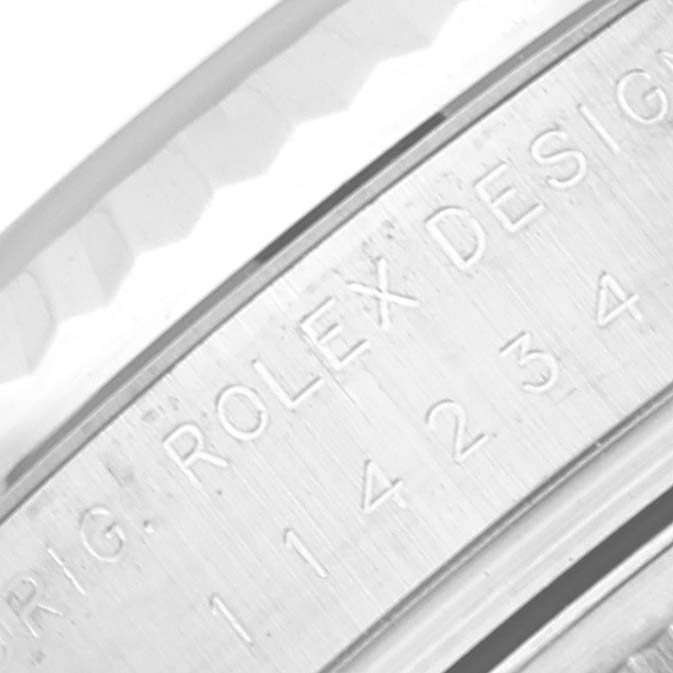 This close-up image shows part of the casing with engraved markings of a Rolex Air-King 114234 Men's Stainless Steel Silver Dial 114234 Men's Stainless Steel Silver Dial watch.