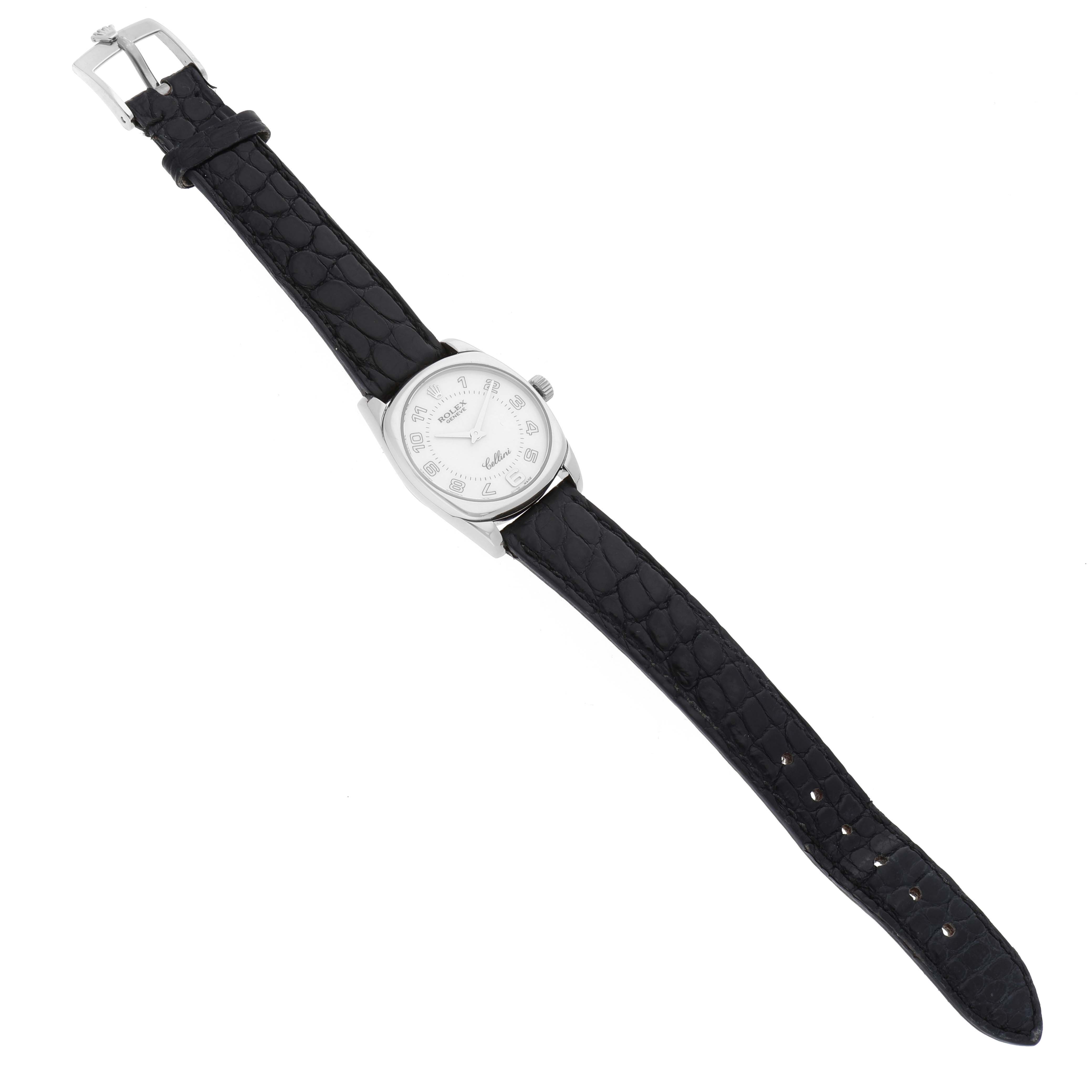 The Rolex Cellini 6229 Women's White Gold White Dial 6229 Women's White Gold White Dial watch is shown from a top-down angle, displaying the face, case, and black leather strap with a buckle.