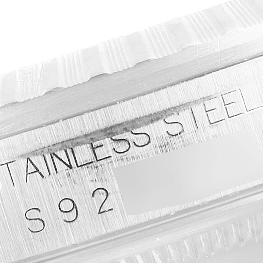 This close-up image shows the stainless steel engraving on the bezel of a Rolex Datejust 16220 Men's Stainless Steel Pink Dial 16220 Men's Stainless Steel Pink Dial watch.