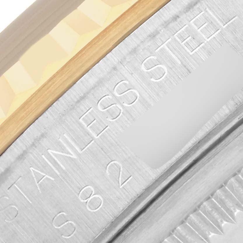 The image shows a close-up of the Rolex Datejust 16233 Men's Steel and Gold (two tone) Black Dial 16233 Men's Steel and Gold (two tone) Black Dial's metal edge, highlighting the "Stainless Steel" engraving.