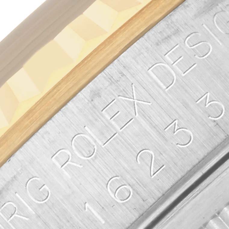 The image shows the side engraving of a Rolex Datejust 16233 Men's Steel and Gold (two tone) Black Dial 16233 Men's Steel and Gold (two tone) Black Dial, highlighting the model and design details.