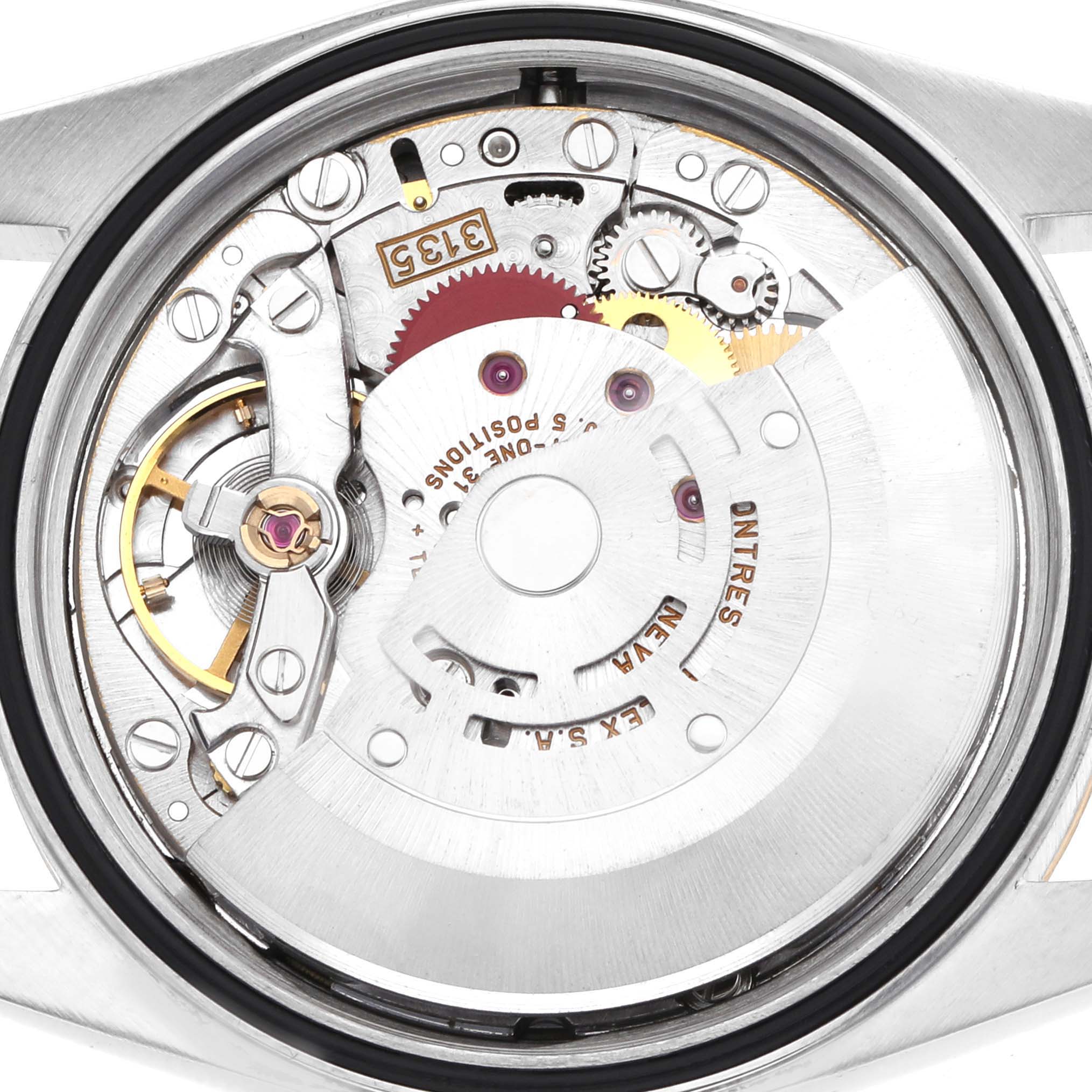 The image shows the movement mechanism of the Rolex Datejust 16233 Men's Steel and Gold (two tone) Champagne Dial, highlighting gears and intricate internal parts from the back.