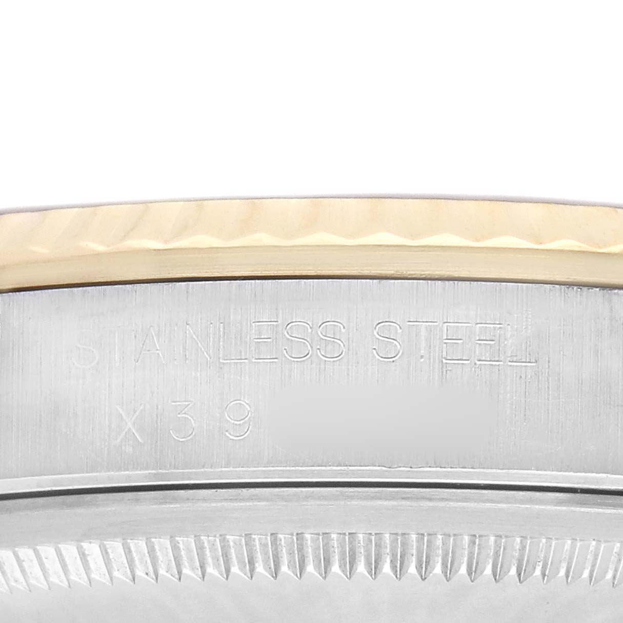 The image shows a close-up of the Rolex Datejust 16233 Men's Steel and Gold (two tone) Champagne Dial's case side, highlighting the stainless steel engraving.
