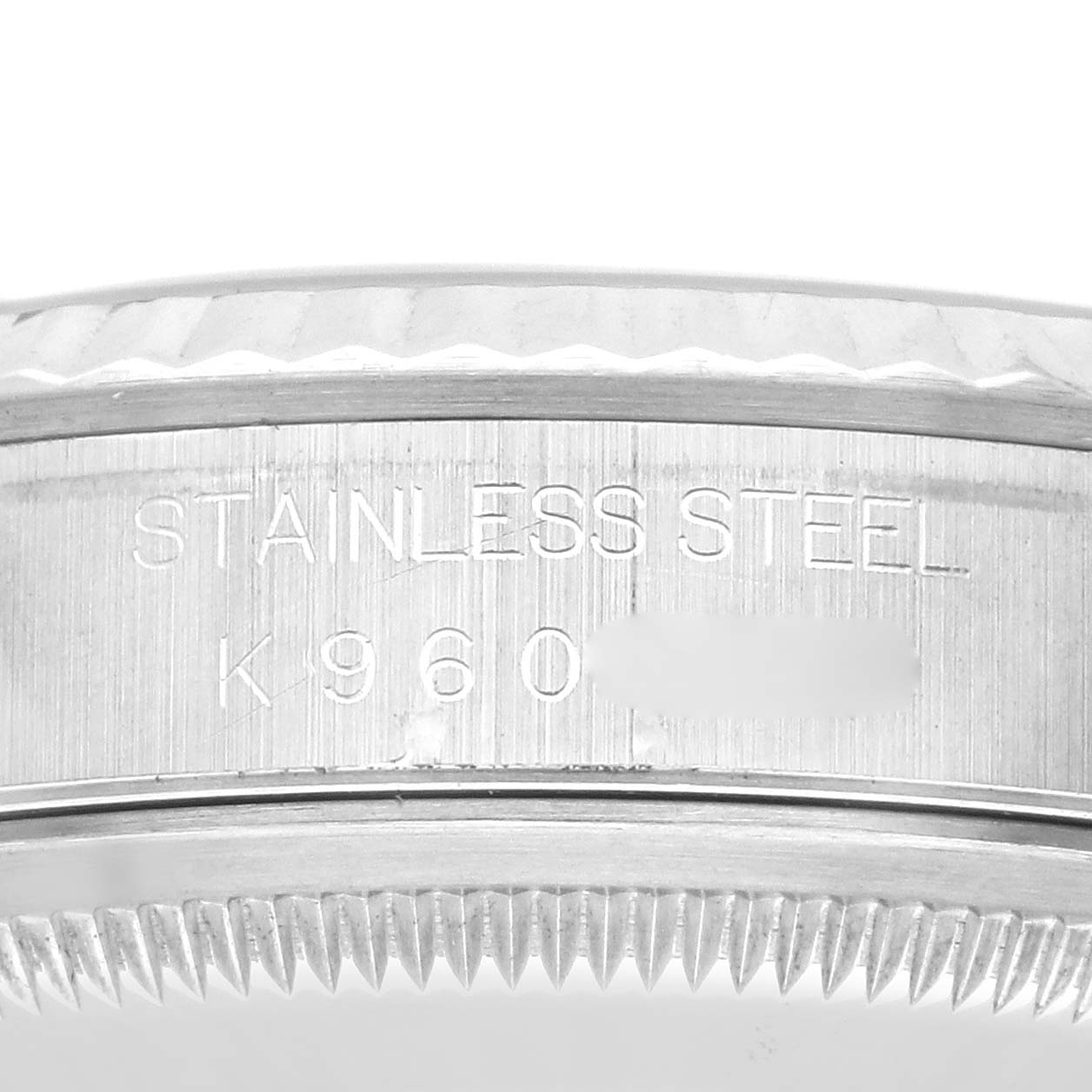 The image shows a close-up of the side of a Rolex Datejust 16234 Men's Stainless Steel Black Dial 16234 Men's Stainless Steel Black Dial watch, focusing on the engraved text and bezel edge.