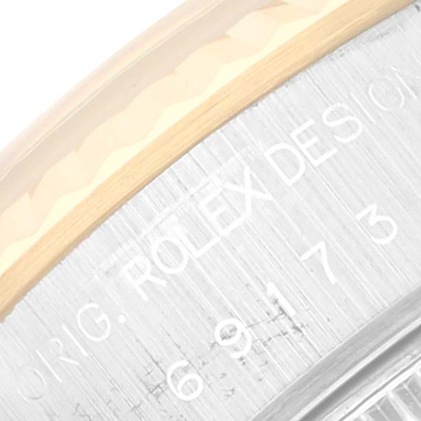 The image shows a close-up of the side of the Rolex Datejust 69173 Women's Steel and Gold (two tone) Champagne Dial 69173 Women's Steel and Gold (two tone) Champagne Dial watch, focusing on the engraved serial and model number.