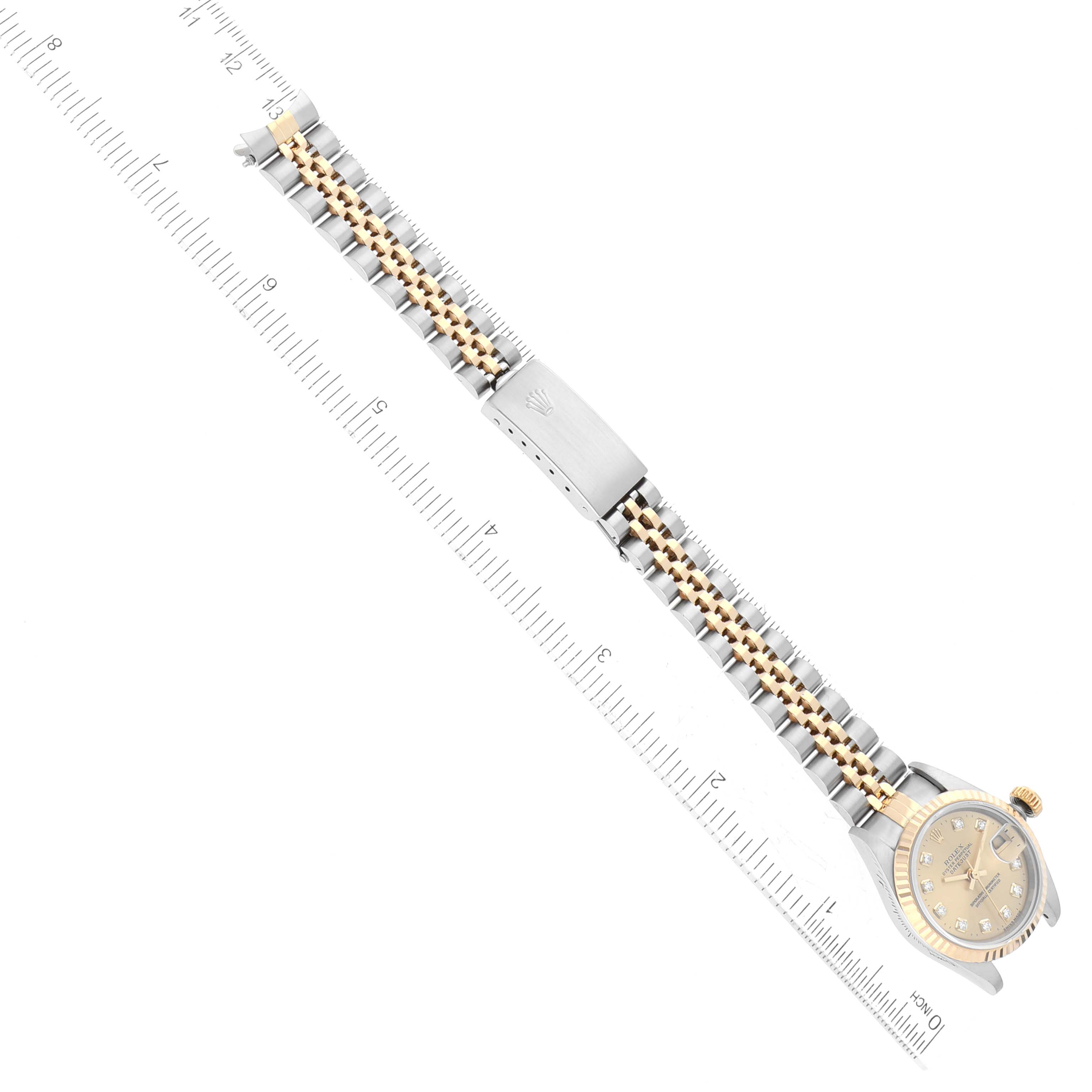 The Rolex Datejust 69173 Women's Steel and Gold (two tone) Champagne Dial 69173 Women's Steel and Gold (two tone) Champagne Dial watch is shown from a top-down angle, featuring the full bracelet, clasp, and dial.