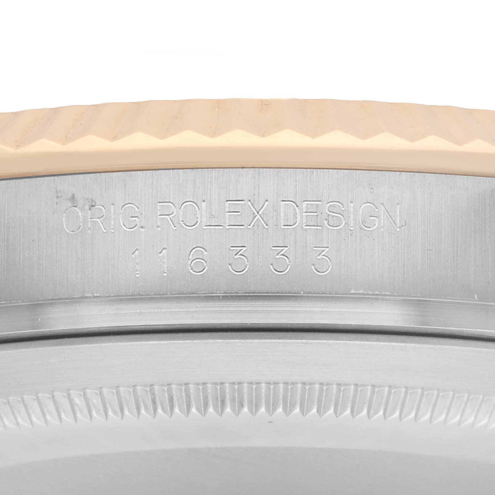 The image shows a close-up of the side of a Rolex Datejust 41 116333 Men's Steel and Gold (two tone) Grey Dial, focusing on the engraved model number and design.
