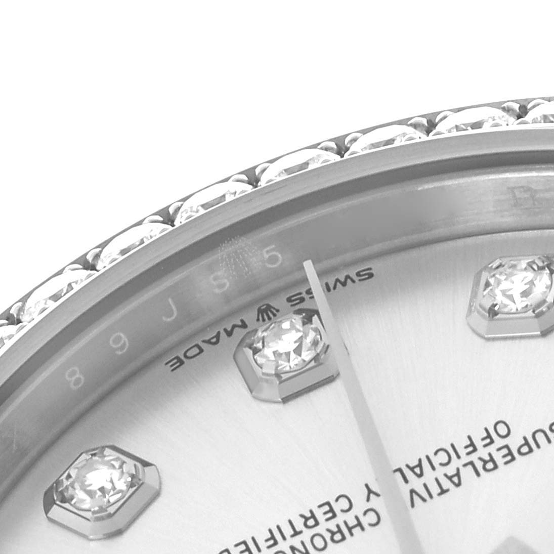 The image shows a close-up of the dial and bezel with gems on a Rolex Mid-Size 278384 Women's Stainless Steel Silver Dial 278384 Women's Stainless Steel Silver Dial watch, including part of the hour markers and hands.