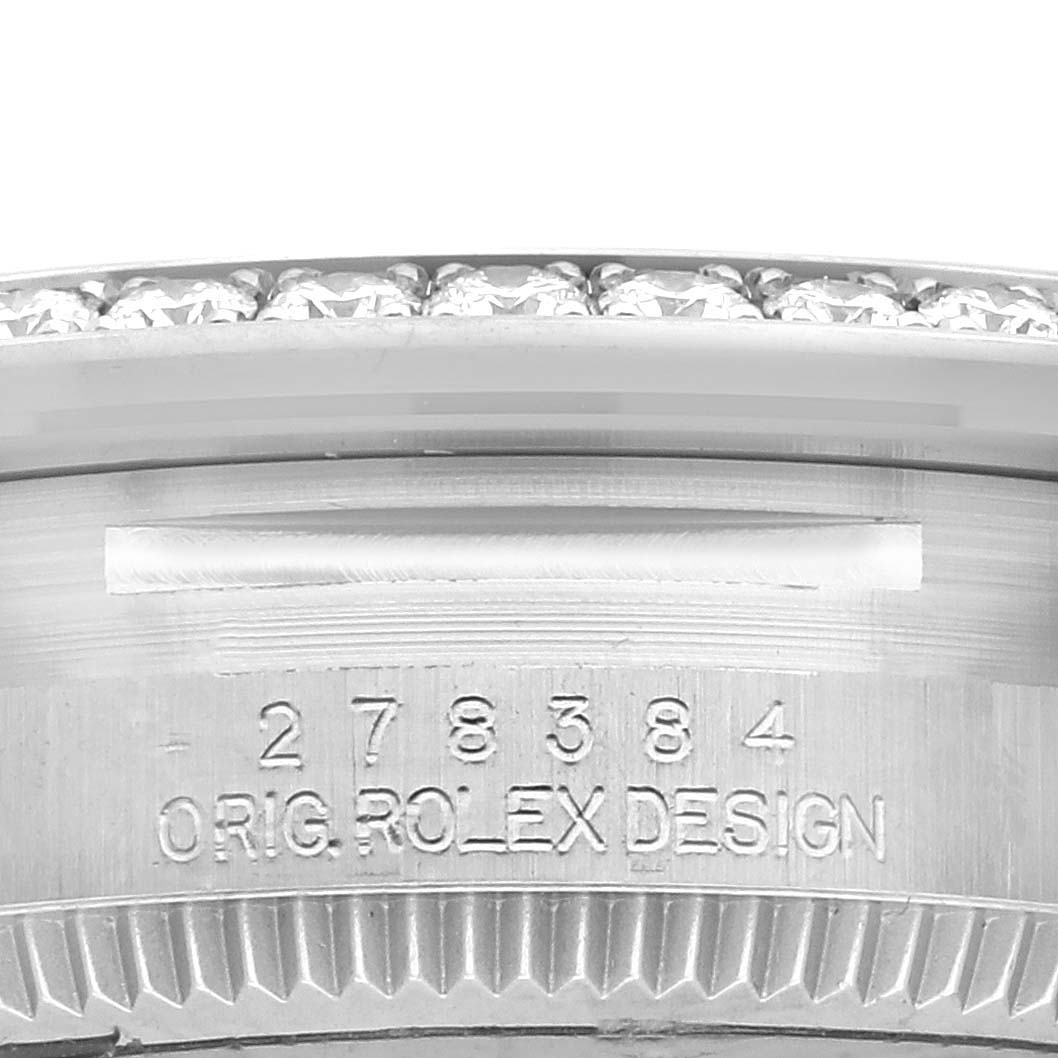 The image shows a close-up of the bezel and serial engraving on a Rolex Mid-Size 278384 Women's Stainless Steel Silver Dial 278384 Women's Stainless Steel Silver Dial watch, highlighting its detailing.