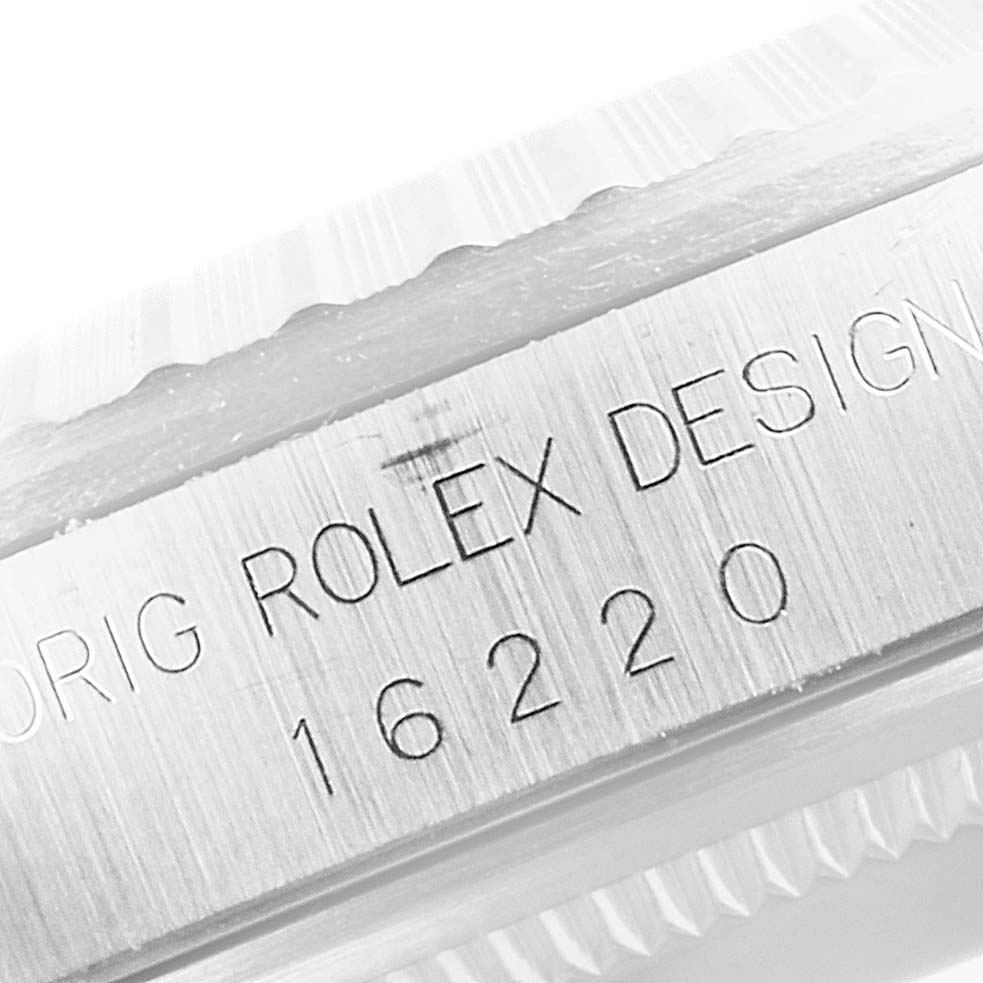 This close-up angle shows the engraved serial number and "ROLEX DESIGN" text on the Datejust model by Rolex.