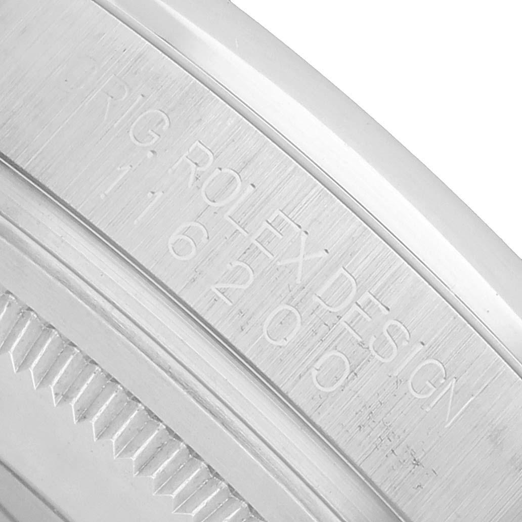 The image shows a close-up of the engraved side portion of a Rolex Datejust 116200 Men's Stainless Steel Black Dial watch casing.