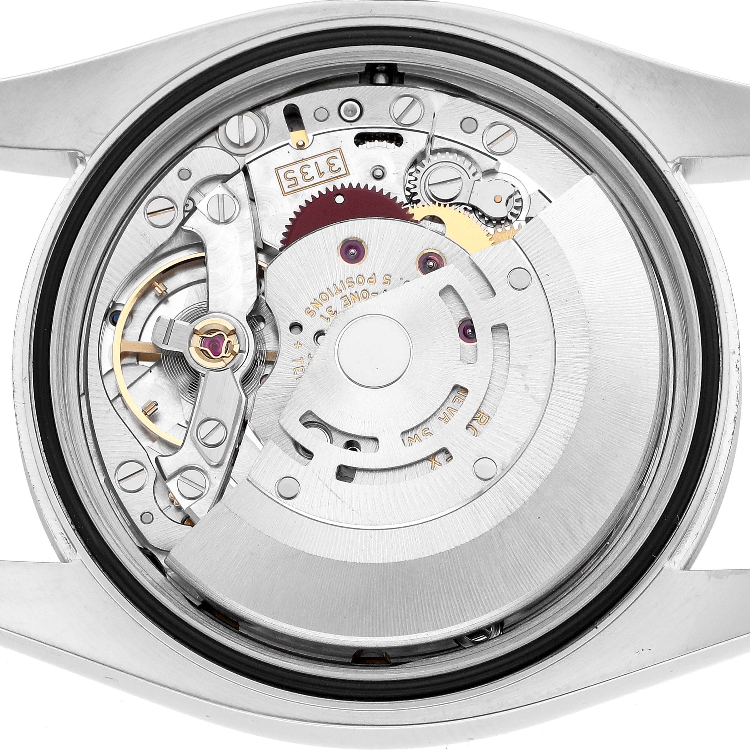 The image shows the movement of a Rolex Datejust 116200 Men's Stainless Steel Black Dial watch from a back case angle, highlighting its intricate internal components.