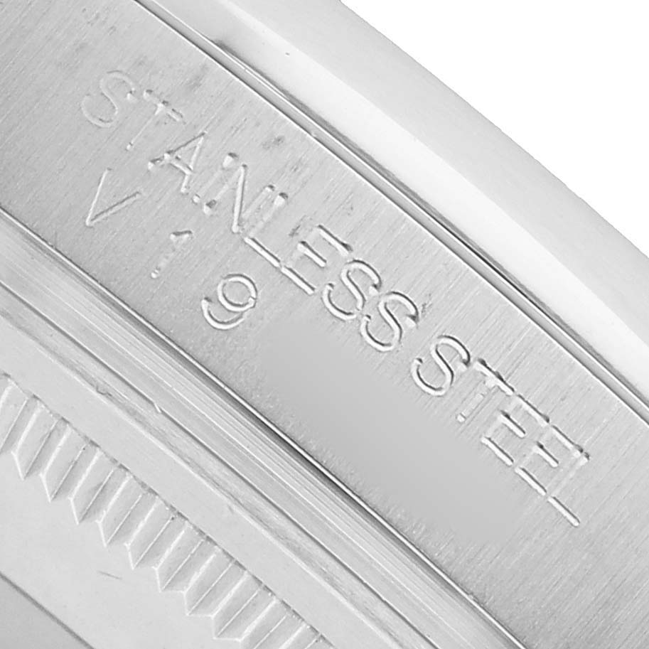 The image shows the side engraving of a Rolex Datejust 116200 Men's Stainless Steel Black Dial watch, focusing on the "STAINLESS STEEL" marking.