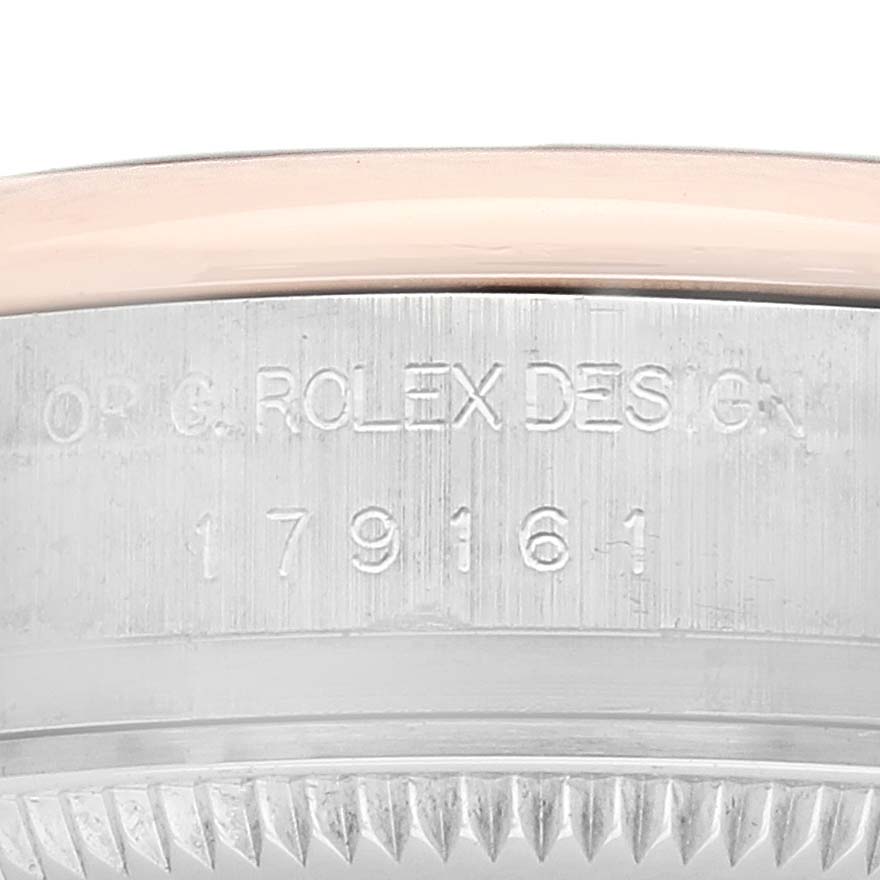 The image shows the side view of a Rolex Datejust 179161 Women's Rose Gold Blue Dial watch, highlighting the engraved design numbers on the case.