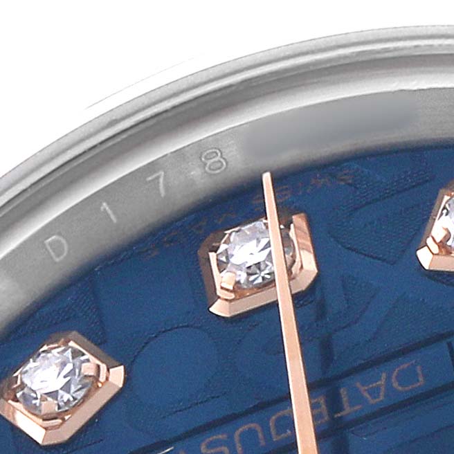 The image shows a close-up of a Rolex Datejust 179161 Women's Rose Gold Blue Dial watch, featuring part of its dial and diamond hour markers.