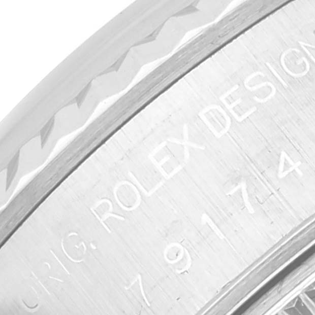 This close-up image shows the engraved side of a Rolex Datejust 79174 Women's Stainless Steel Blue Dial 79174 Women's Stainless Steel Blue Dial watch case.