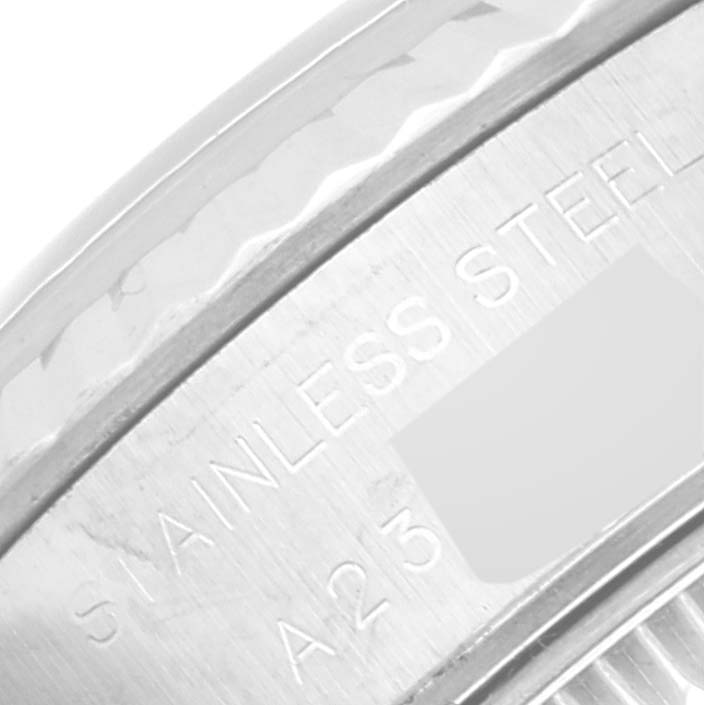 This close-up image shows part of the bezel and the engraved text "STAINLESS STEEL" on the case of a Rolex Datejust 79174 Women's Stainless Steel Blue Dial 79174 Women's Stainless Steel Blue Dial watch.