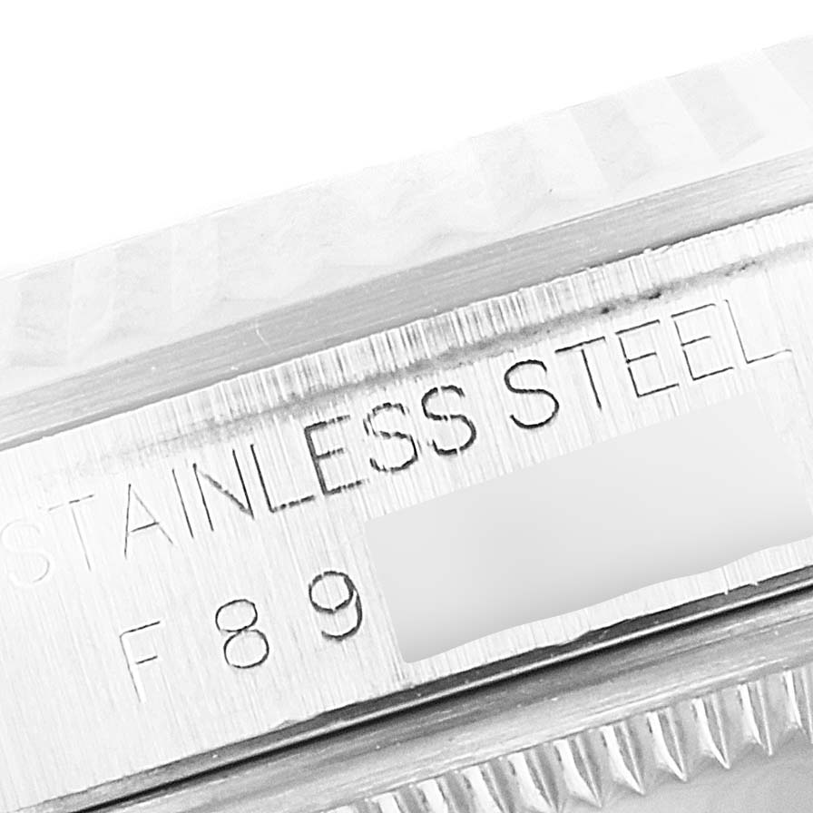 This close-up image shows the stainless steel bezel and serial number engraving of a Rolex Datejust 16234 Men's Stainless Steel Silver Dial 16234 Men's Stainless Steel Silver Dial watch.