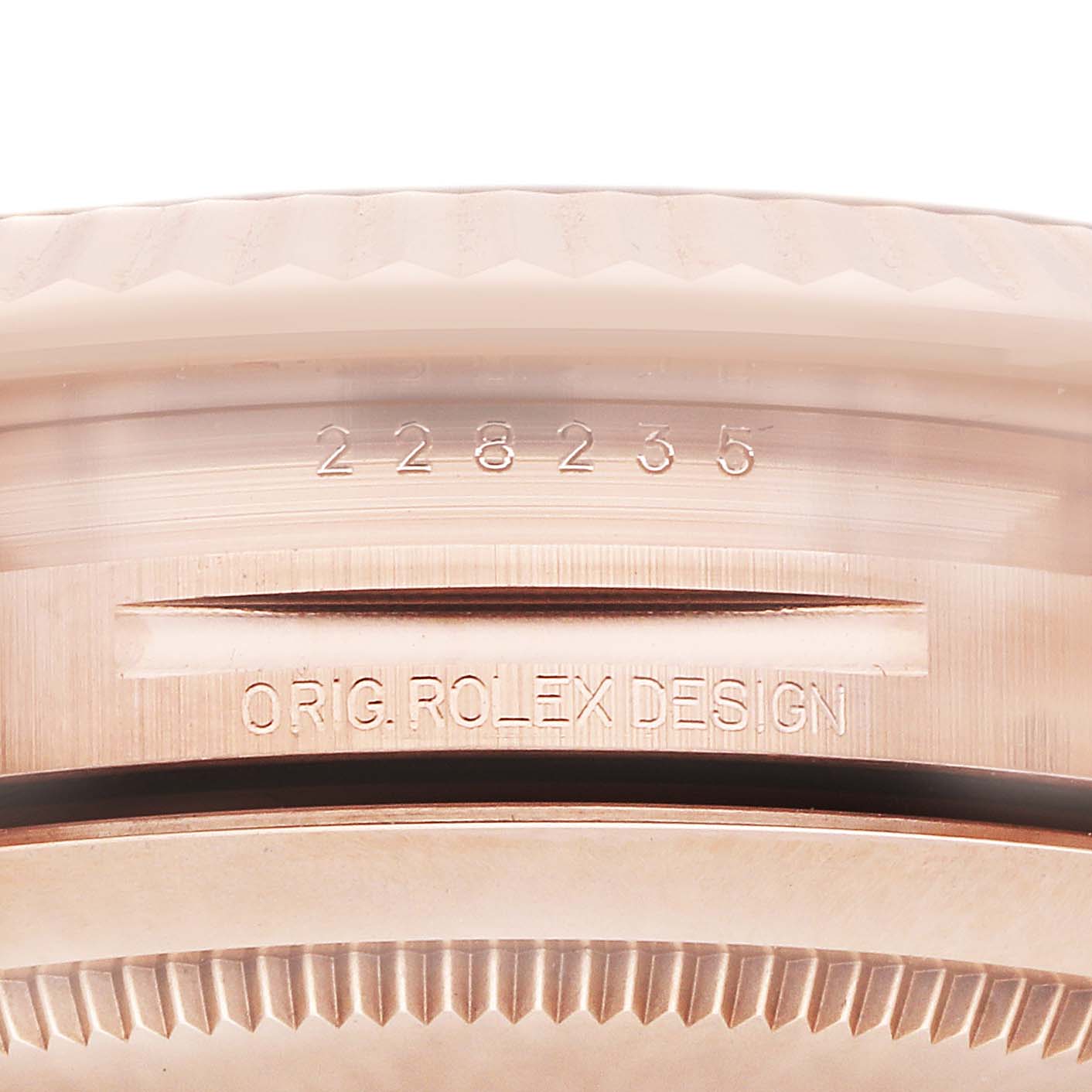 The image shows a close-up of the edge and case back of a Rolex President 228235 Men's Rose Gold Green Dial watch, highlighting the reference number and design engraving.