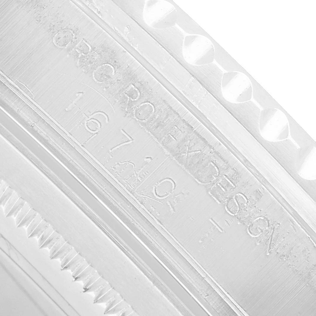 The image shows an extreme close-up of the edge and engraved reference number on a Rolex GMT-Master 16710 Men's Stainless Steel Black Dial watch case.