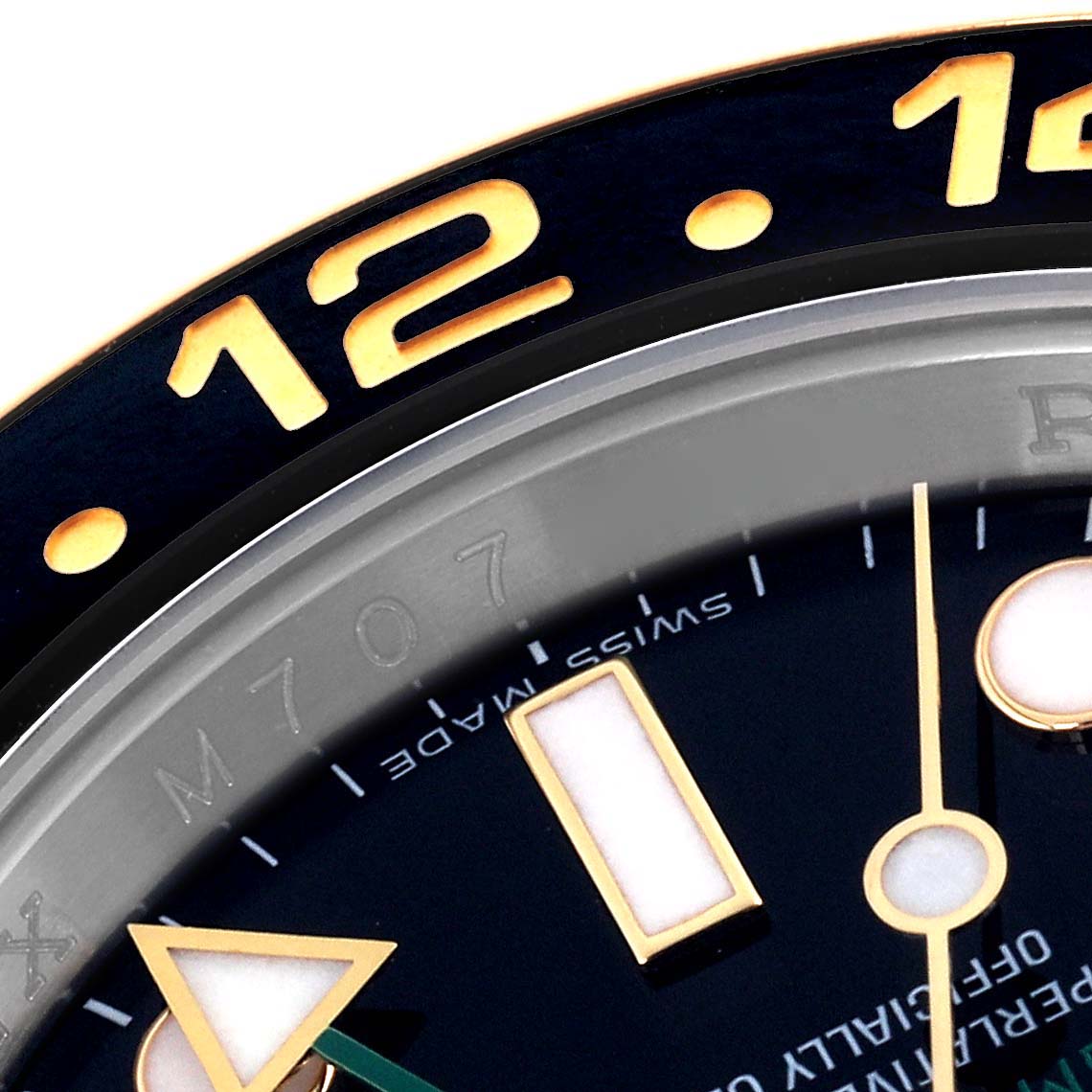 The image shows a close-up of the Rolex GMT-Master 116713 Men's Steel and Gold (two tone) Black Dial 116713 Men's Steel and Gold (two tone) Black Dial bezel, dial, and part of the indices viewed from an angled perspective.