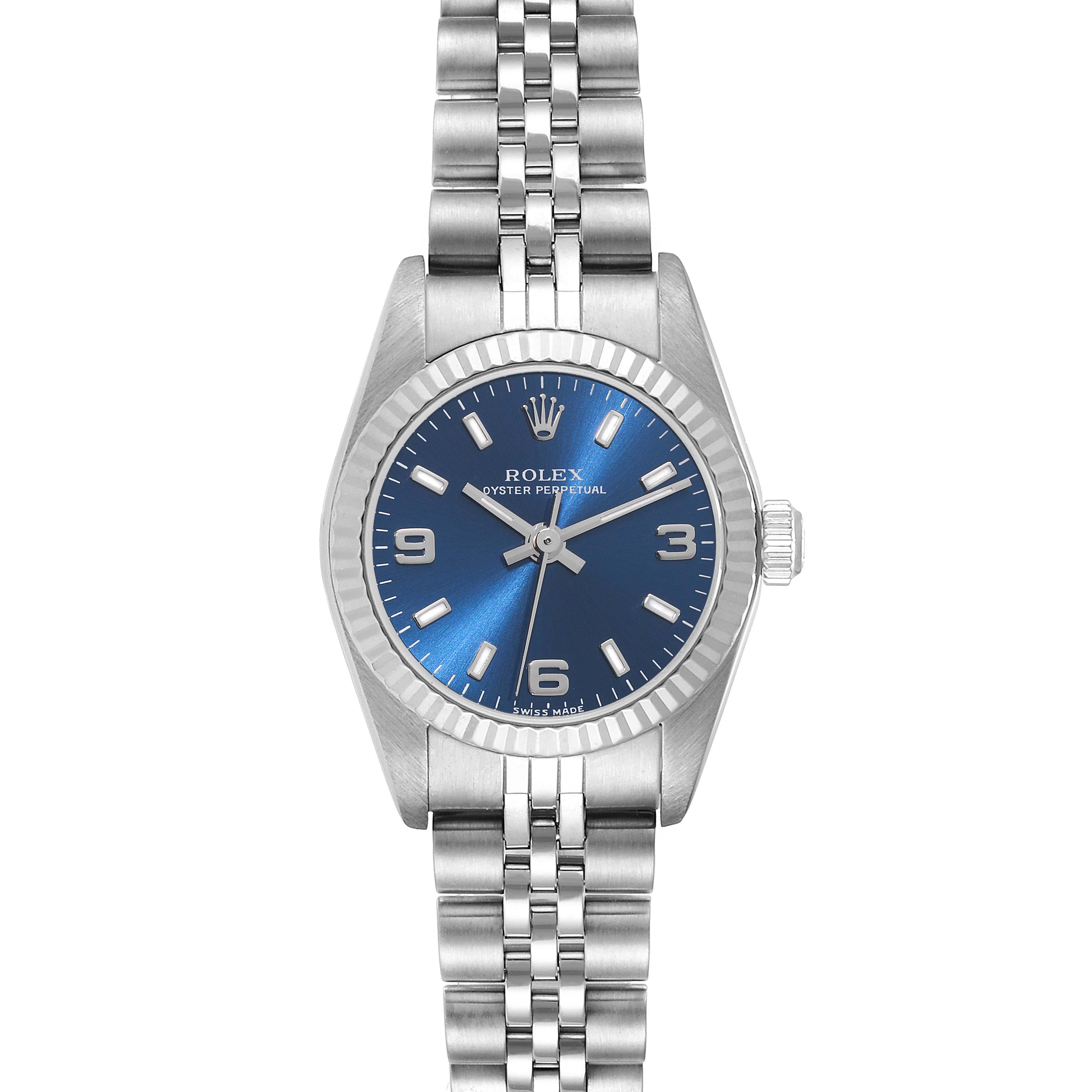 The Rolex Oyster Perpetual 76094 Women's Stainless Steel Blue Dial 76094 Women's Stainless Steel Blue Dial watch is shown from a top-down angle, featuring its blue dial, silver hour markers, and metal bracelet.