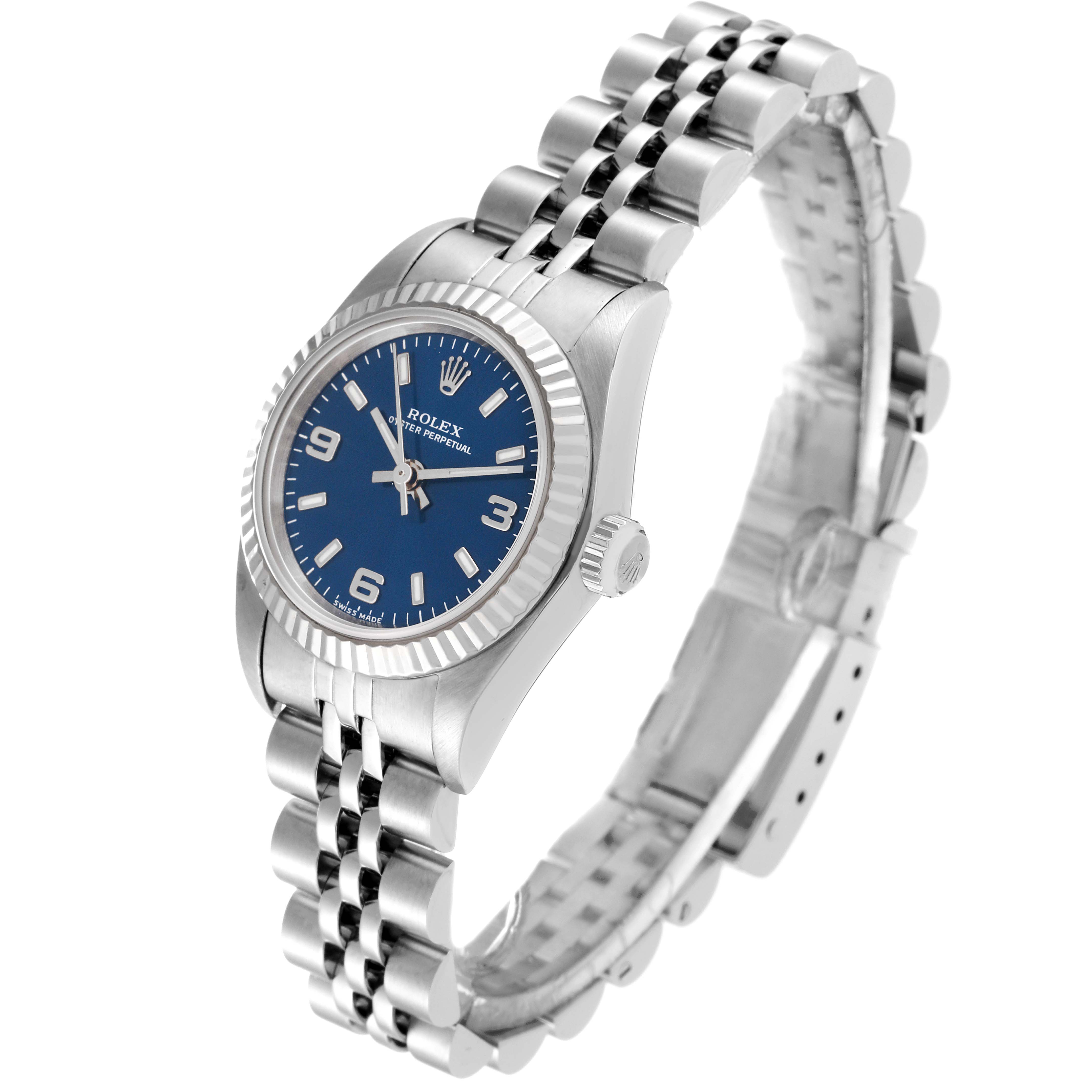 This image shows a side-angle view of the Rolex Oyster Perpetual 76094 Women's Stainless Steel Blue Dial 76094 Women's Stainless Steel Blue Dial watch, highlighting the blue dial, fluted bezel, and stainless steel bracelet.