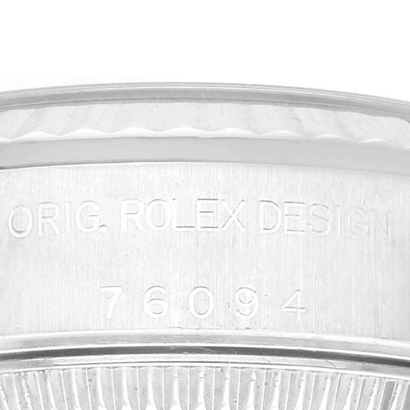 The image shows a close-up side view of a Rolex Oyster Perpetual 76094 Women's Stainless Steel Blue Dial 76094 Women's Stainless Steel Blue Dial watch case with the engravings "ORIG. ROLEX DESIGN" and "76094."