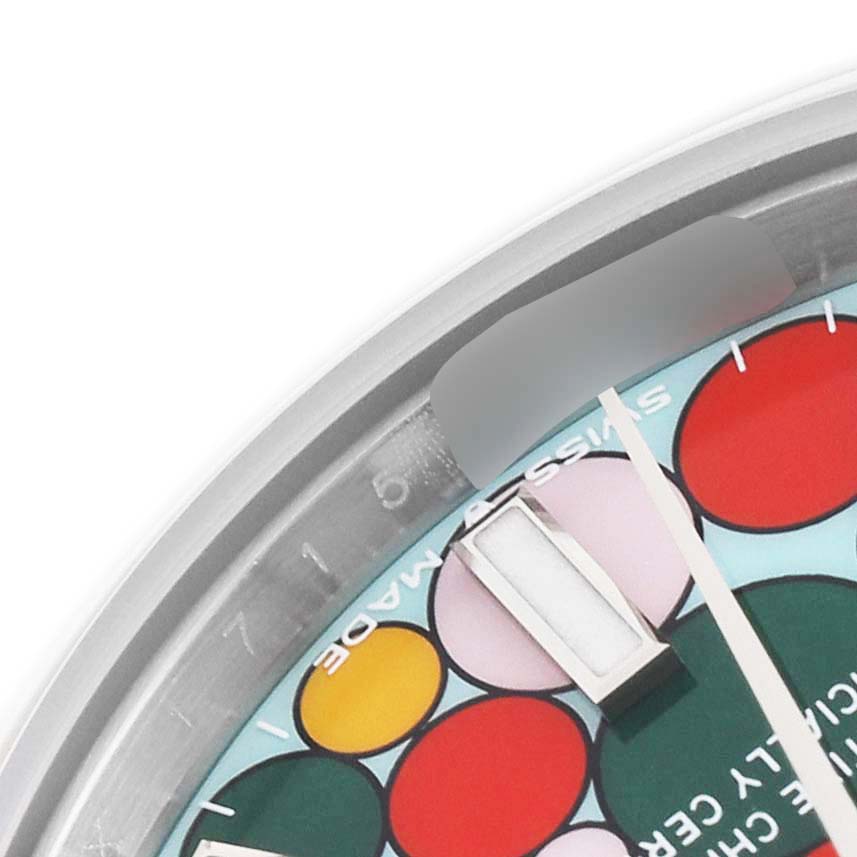 This image shows a close-up of the dial and partial bezel of a Rolex Mid-Size 277200 Women
s Stainless Steel Blue Dial 277200 Women
s Stainless Steel Blue Dial watch, focusing on the colorful markers and an hour hand.
