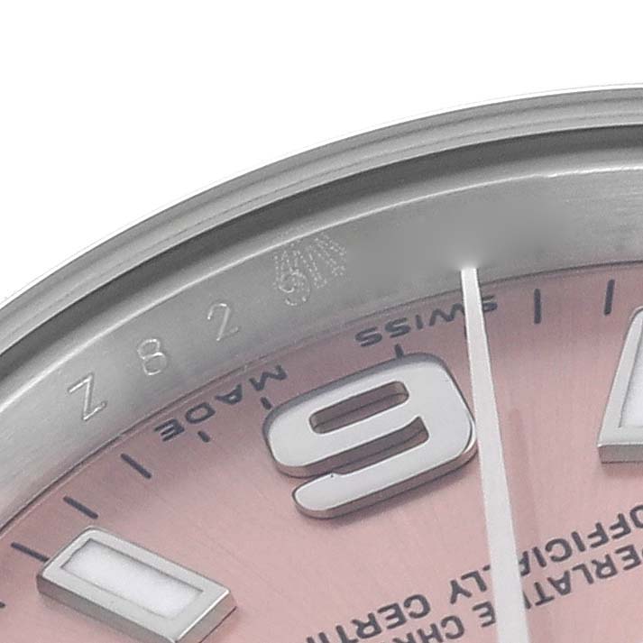 The image shows a close-up angle of the dial and bezel of a Rolex Oyster Perpetual 176200 Women's Stainless Steel Pink Dial 176200 Women's Stainless Steel Pink Dial watch, featuring part of the 9 o'clock marker.