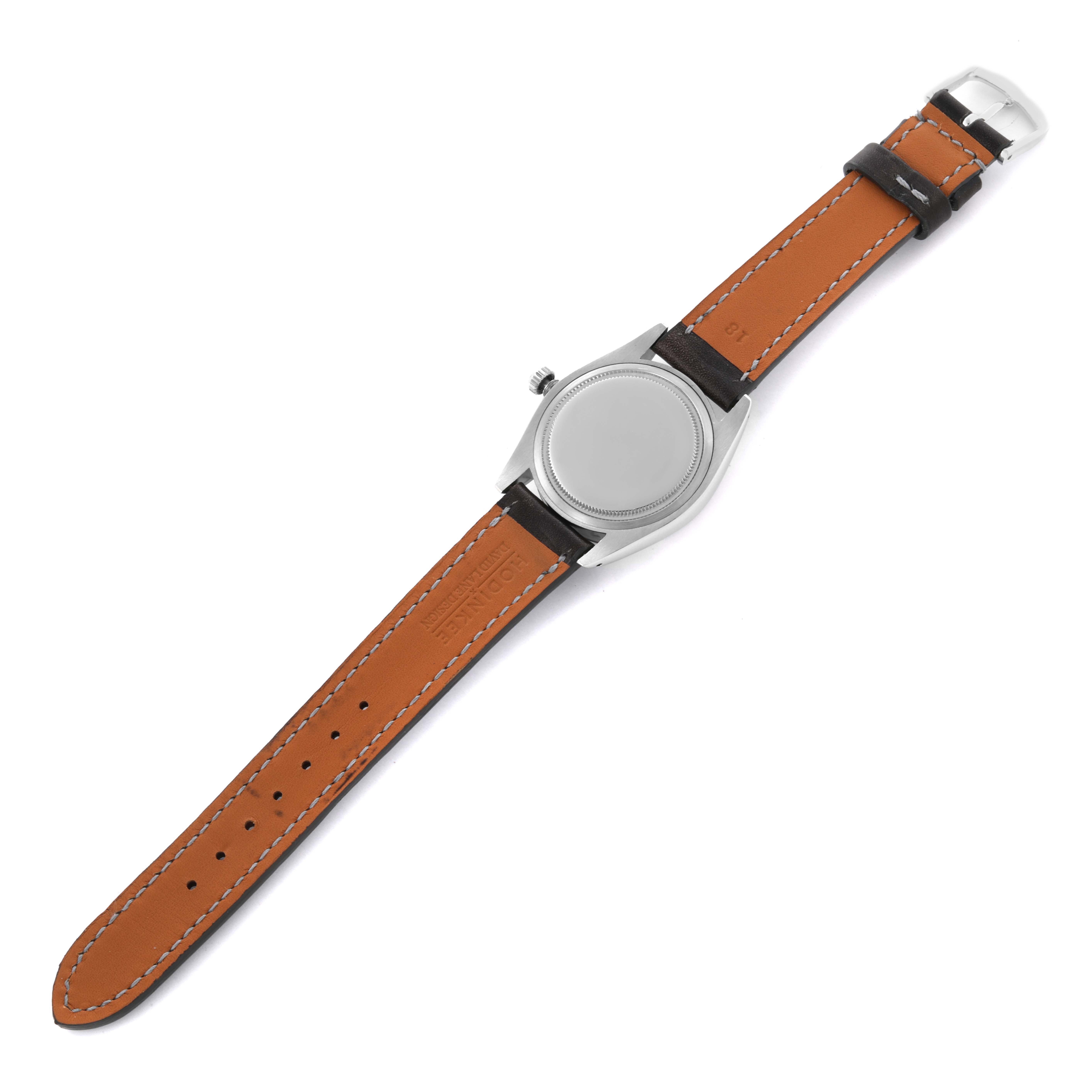 The image shows a Rolex Vintage Collection 6694 Men's Stainless Steel Black Dial 6694 Men's Stainless Steel Black Dial watch from the back, highlighting the leather strap and watch case.