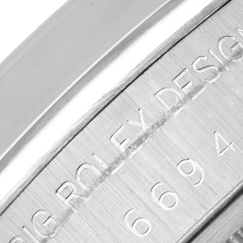 The image shows a close-up angle of the Rolex Vintage Collection 6694 Men's Stainless Steel Black Dial 6694 Men's Stainless Steel Black Dial's engraved casing details.