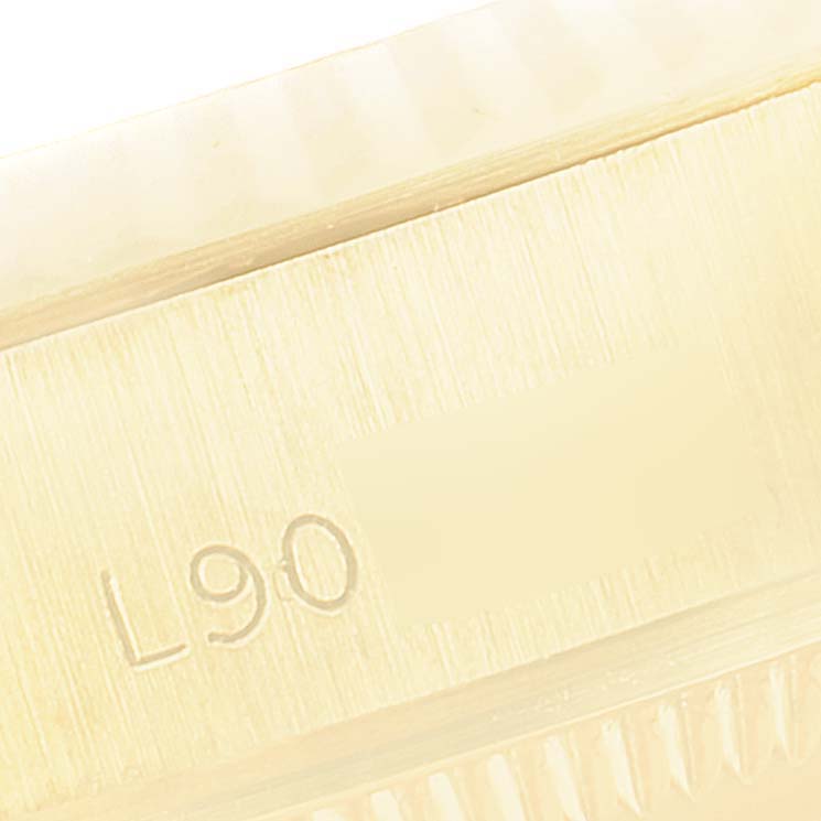 This close-up image shows the side of the case of a Rolex President 69178 Women's Yellow Gold Champagne Dial 69178 Women's Yellow Gold Champagne Dial model, featuring part of its model or serial number.