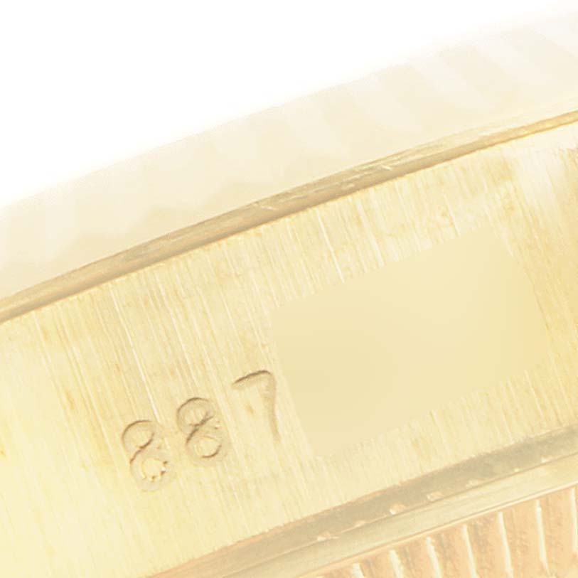 This close-up image of a Rolex President 69178 Women's Yellow Gold Champagne Dial 69178 Women's Yellow Gold Champagne Dial model displays its serial number engraving on the watch case.