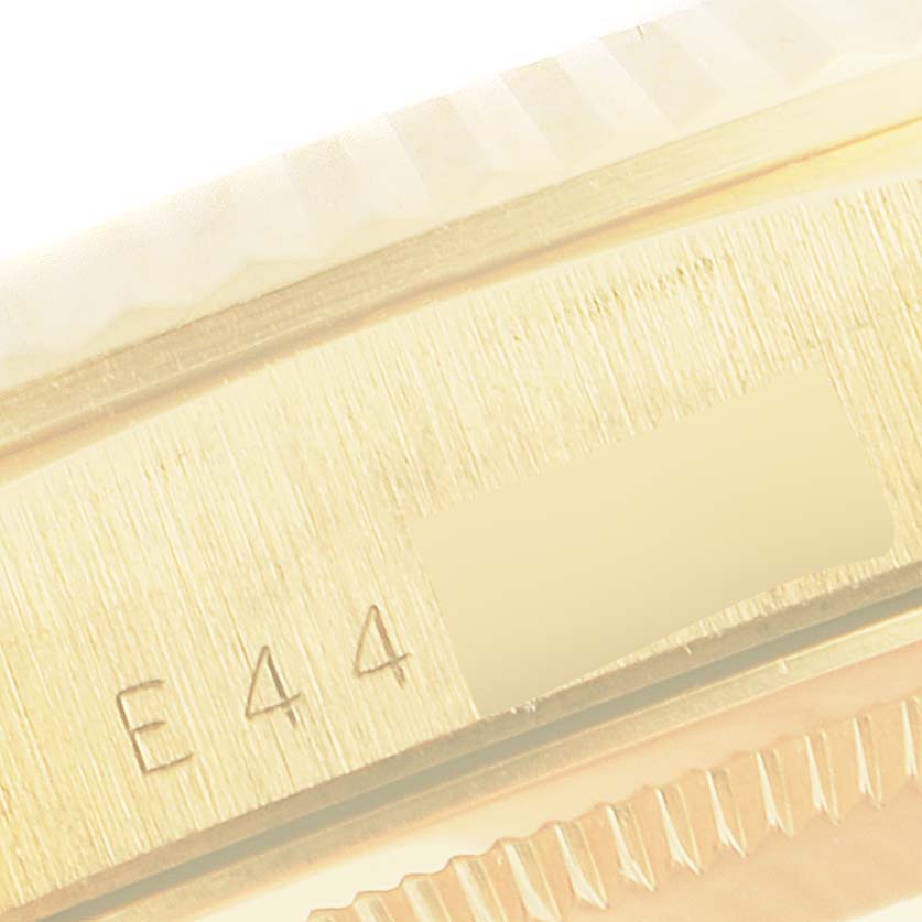 This image shows a close-up angle of the side of a Rolex President 18238 Men's Yellow Gold Champagne Dial 18238 Men's Yellow Gold Champagne Dial watch, showcasing the serial number and the edge of the bezel.