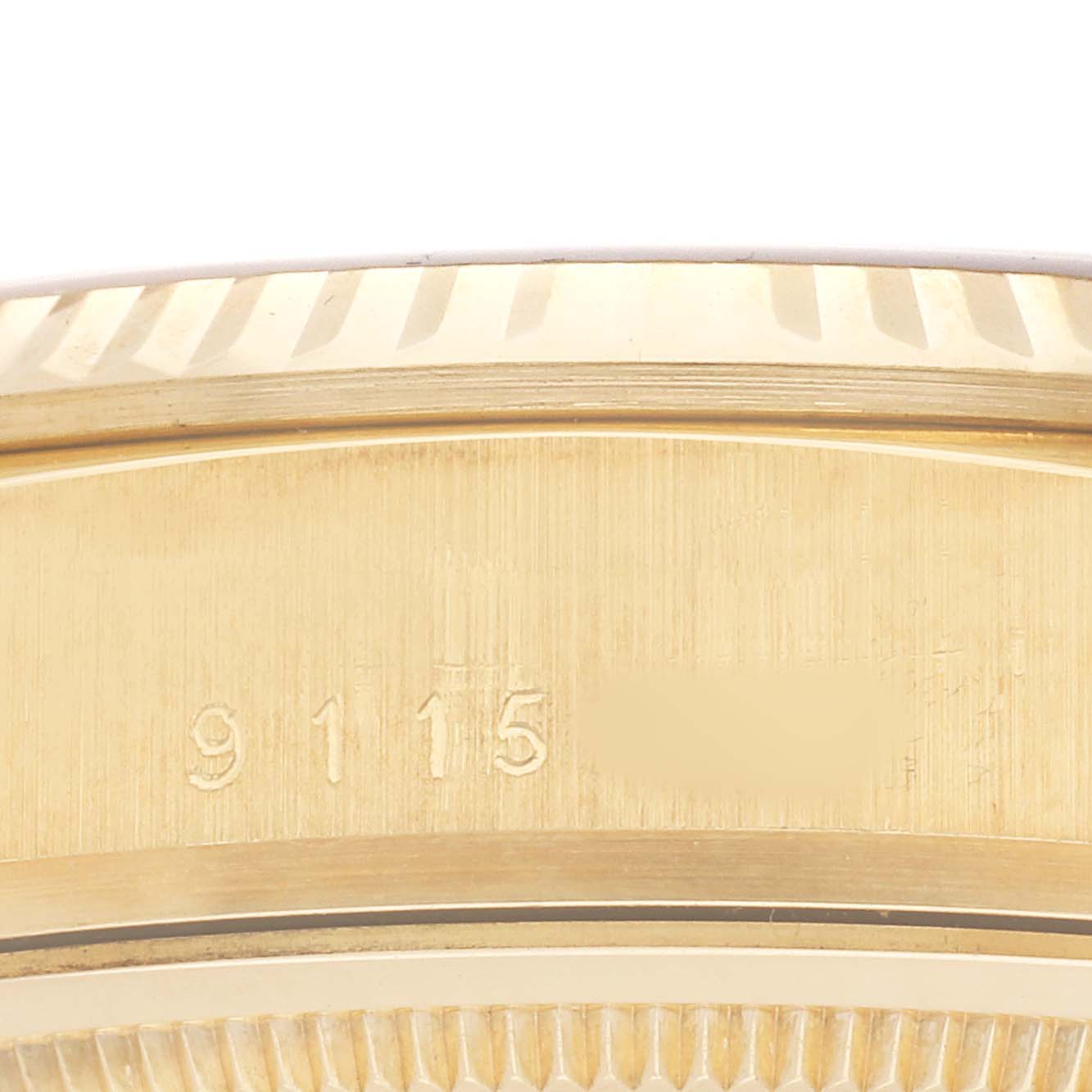 The image shows a close-up of the edge and serial number of the Rolex President 18038 Men's Yellow Gold Silver Dial model.