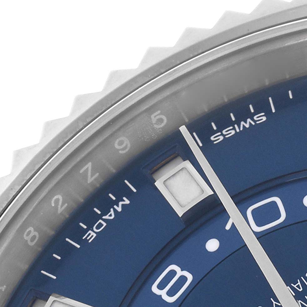 The image shows a close-up of the blue dial and part of the bezel on a Rolex Sky-Dweller 326934 Men's Stainless Steel Blue Dial 326934 Men's Stainless Steel Blue Dial watch.