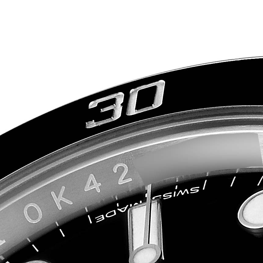 This close-up shows the bezel, part of the dial, and the minute hand of the Rolex Submariner 114060 Men
s Stainless Steel Black Dial 114060 Men
s Stainless Steel Black Dial watch.