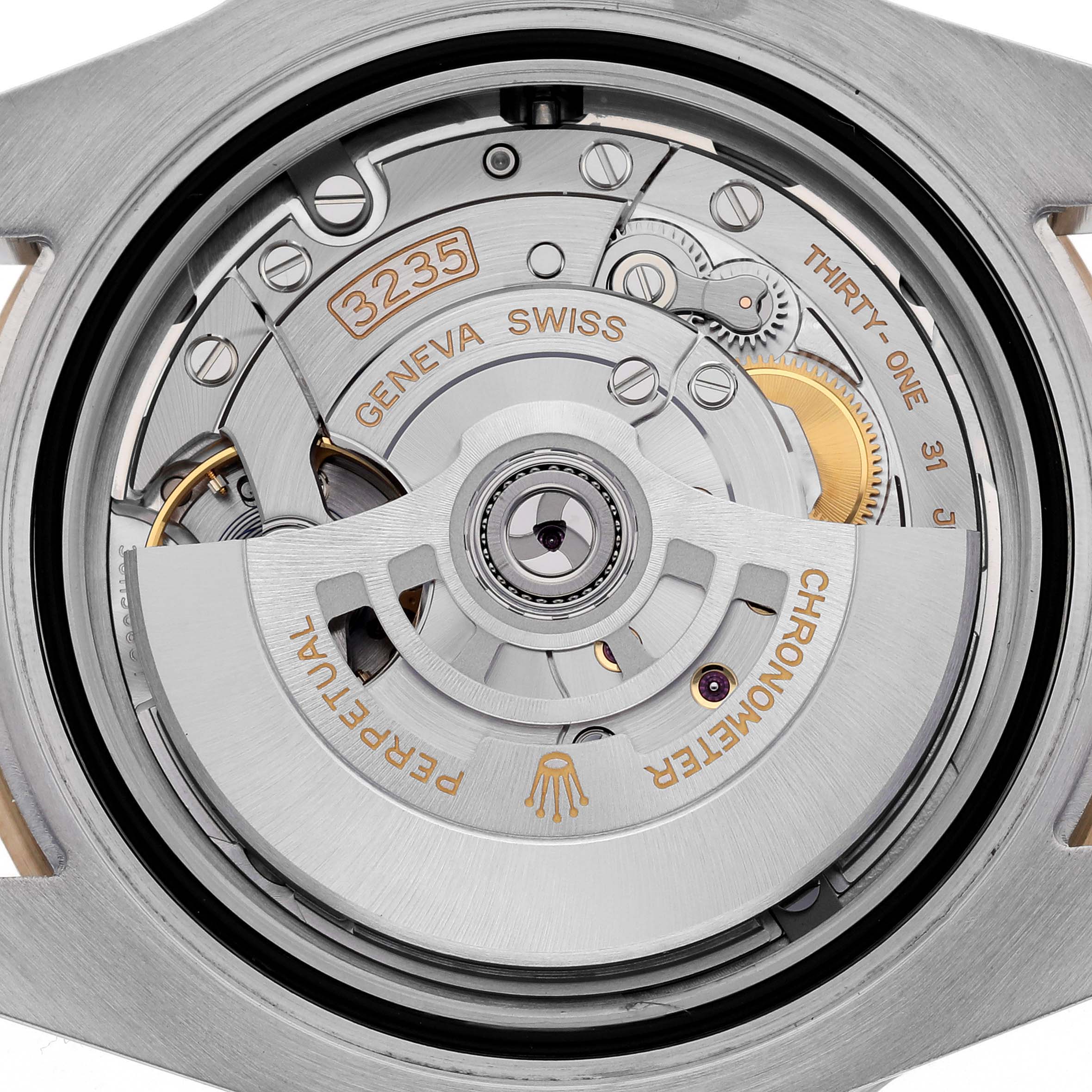 The image shows the movement of a Rolex Submariner 126613 Men's Steel and Gold (two tone) Black Dial 126613 Men's Steel and Gold (two tone) Black Dial, highlighting the automatic rotor and intricate mechanical parts.