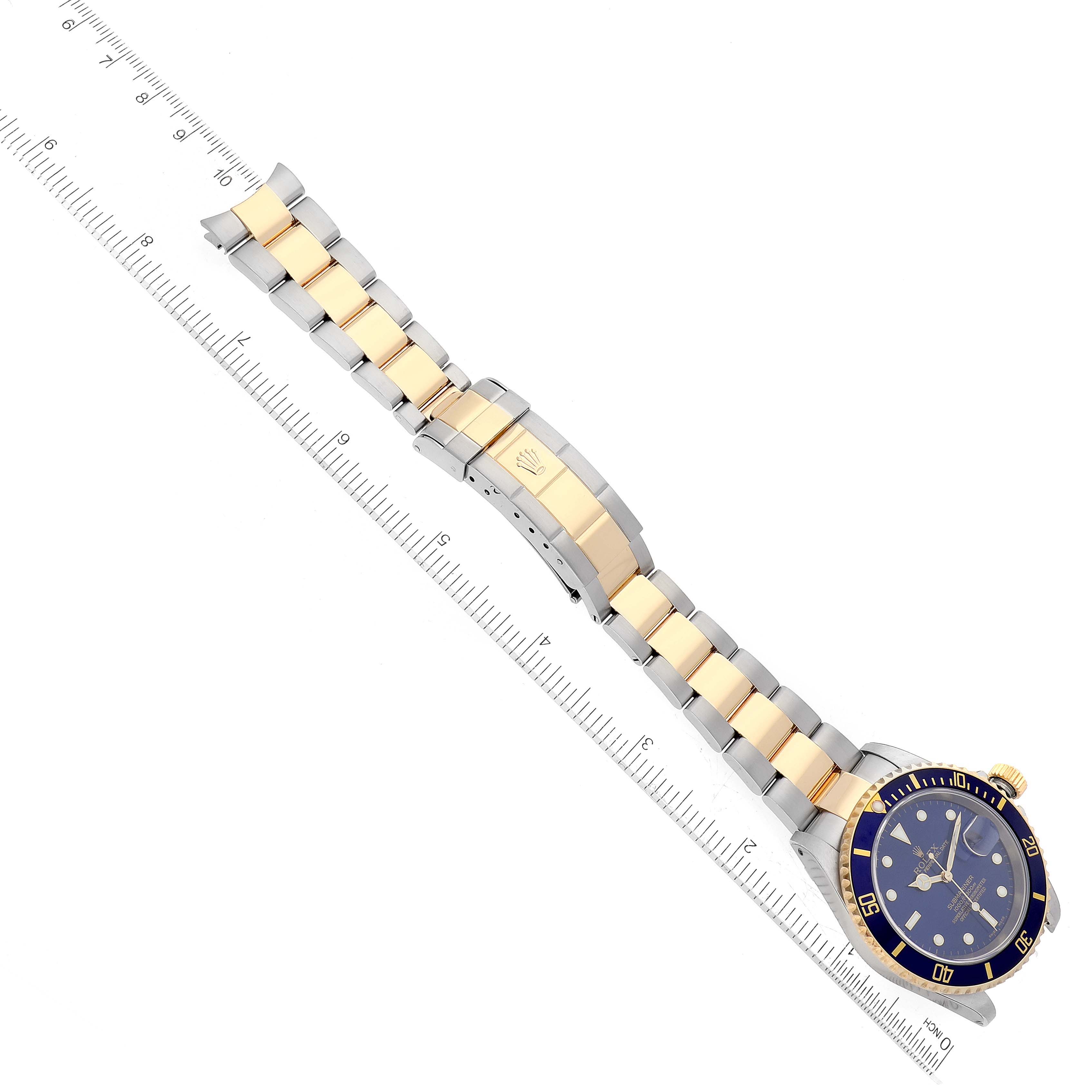 The image shows the Rolex Submariner 16613 Men
s Steel and Gold (two tone) Blue Dial 16613 Men
s Steel and Gold (two tone) Blue Dial watch, including the face, bezel, and two-tone bracelet, from a top-down angle.