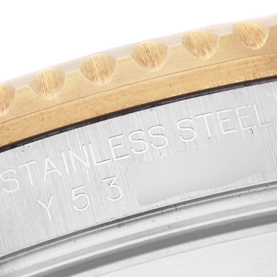 This image shows a close-up of the bezel and part of the case back of a Rolex Submariner 16613 Men
s Steel and Gold (two tone) Blue Dial 16613 Men
s Steel and Gold (two tone) Blue Dial watch, highlighting the "STAINLESS STEEL" engraving.