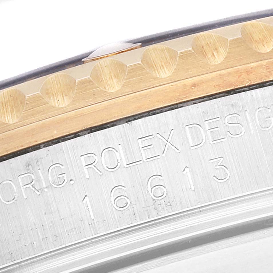 This close-up image shows the bezel and part of the engraved serial number of the Rolex Submariner 16613 Men
s Steel and Gold (two tone) Blue Dial 16613 Men
s Steel and Gold (two tone) Blue Dial model.