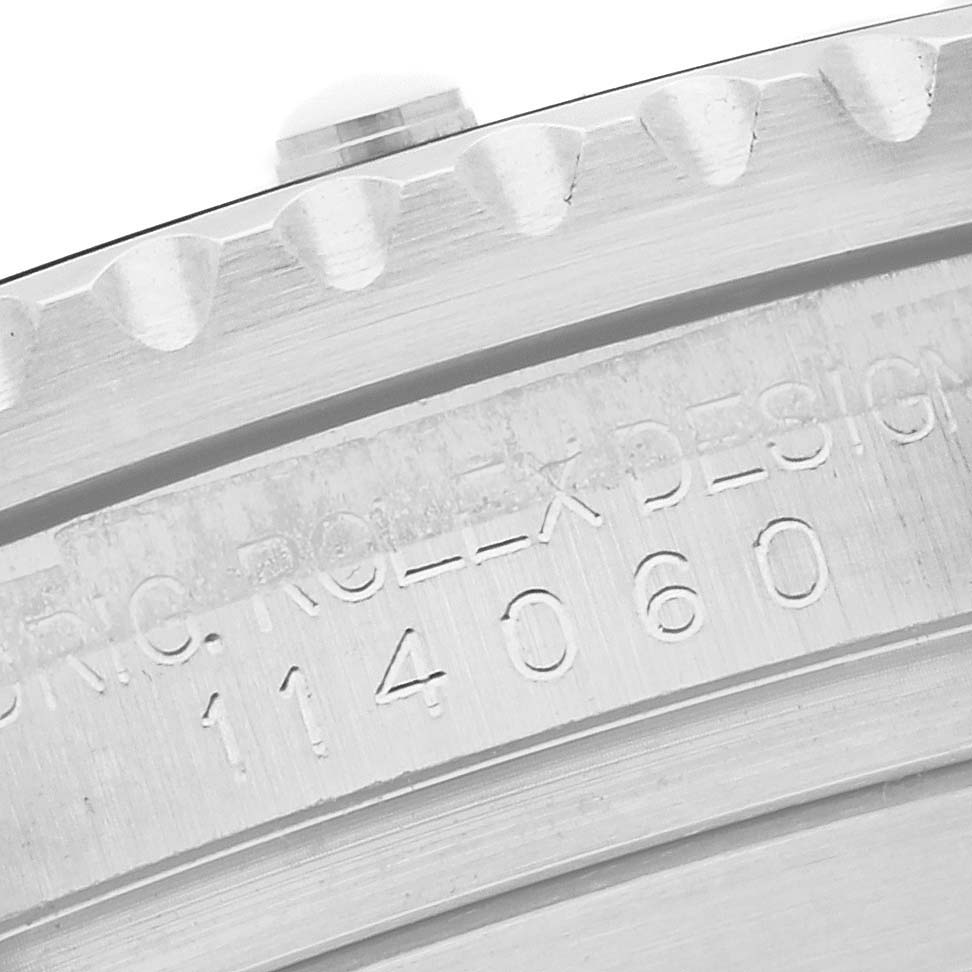 The image shows a close-up of the engraving on the Rolex Submariner 114060 Men's Stainless Steel Black Dial 114060 Men's Stainless Steel Black Dial's case side or bezel edge.