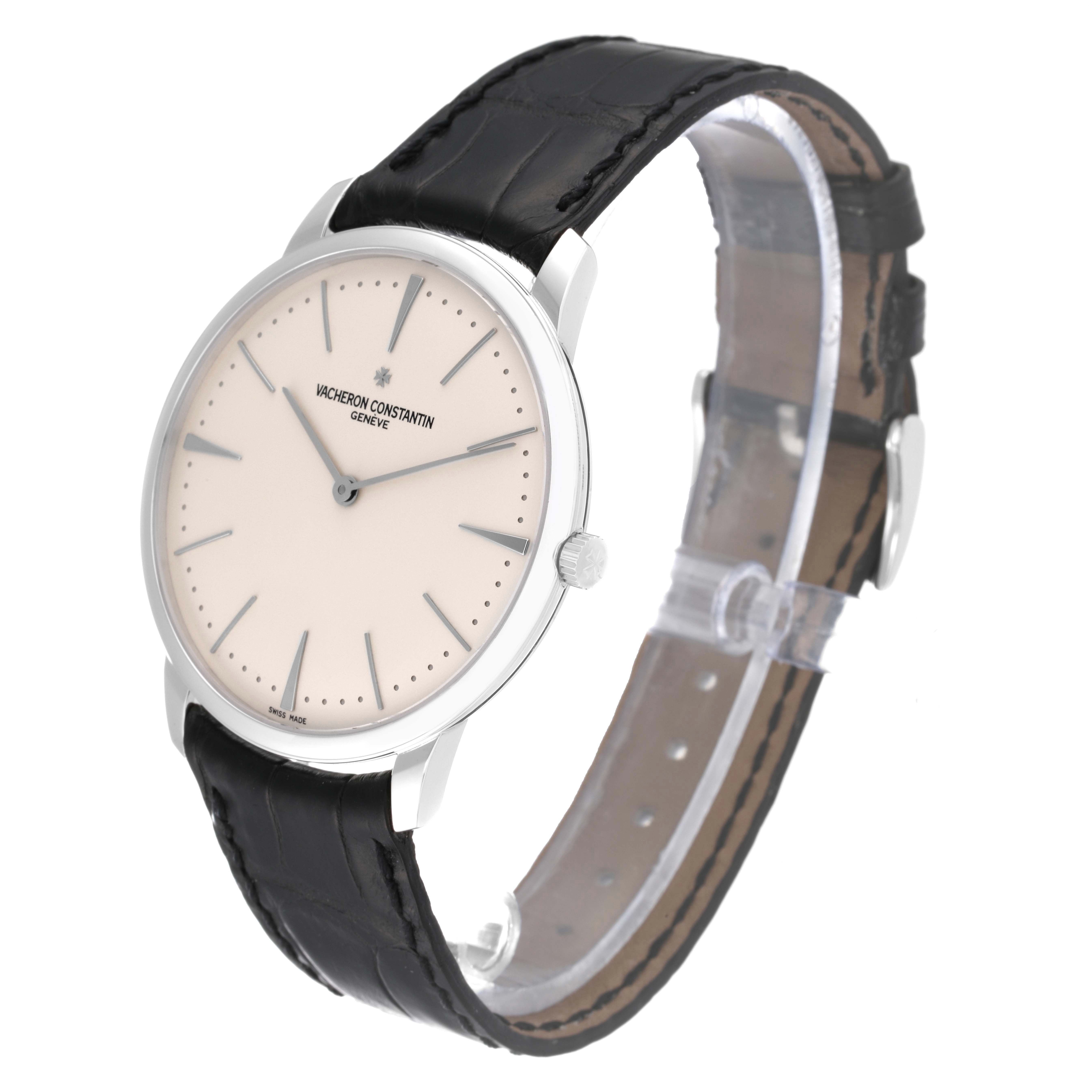 The Patrimony model by Vacheron Constantin is shown at a tilted angle, highlighting the watch face and leather strap.