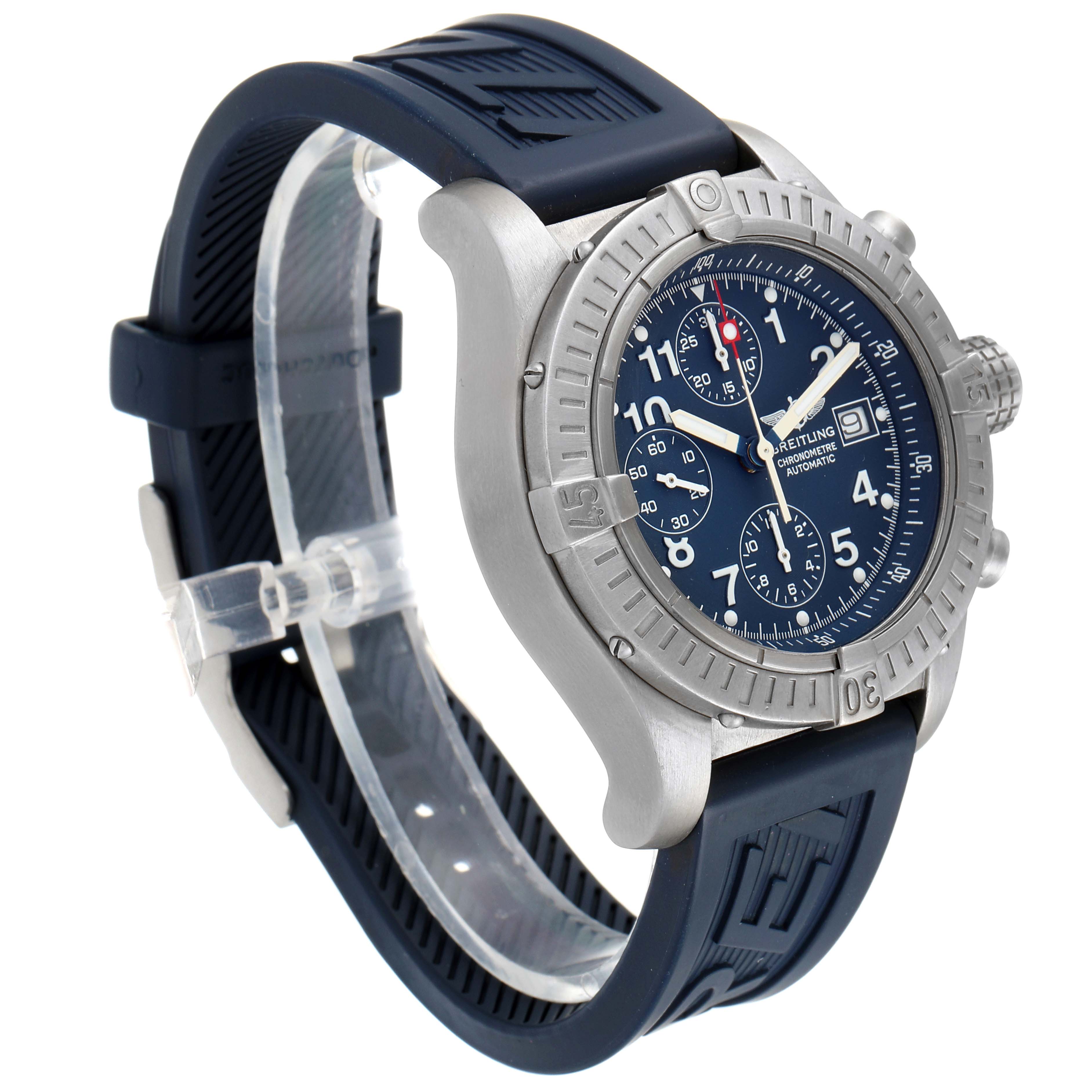 The image shows a Breitling Avenger E13360 Men's Titanium Blue Dial E13360 Men's Titanium Blue Dial wristwatch with a side angle highlighting its blue dial, bezel, and blue rubber strap.