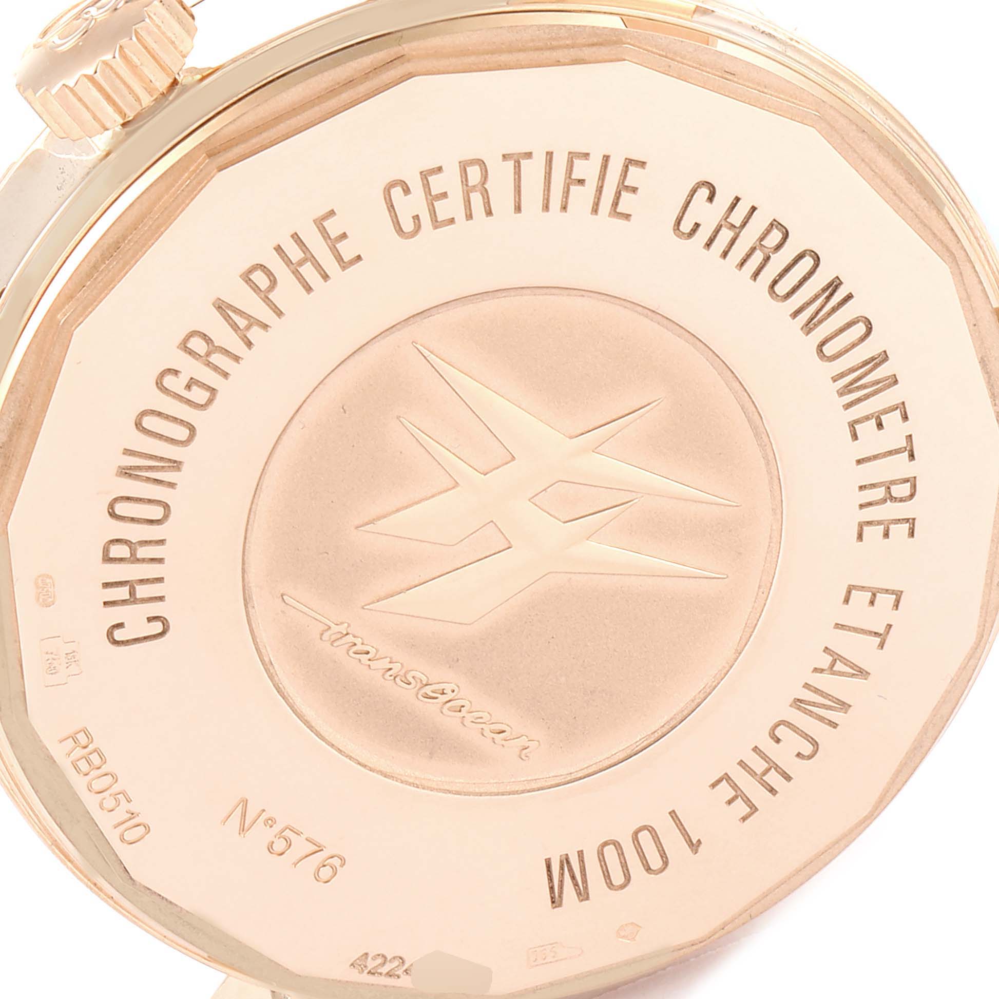 The image shows the back case of the Breitling Transocean RB0510U4-BB63BKLD Men's Rose Gold Black Dial RB0510U4-BB63BKLD Men's Rose Gold Black Dial watch, highlighting its engravings and the crown from a close-up angle.